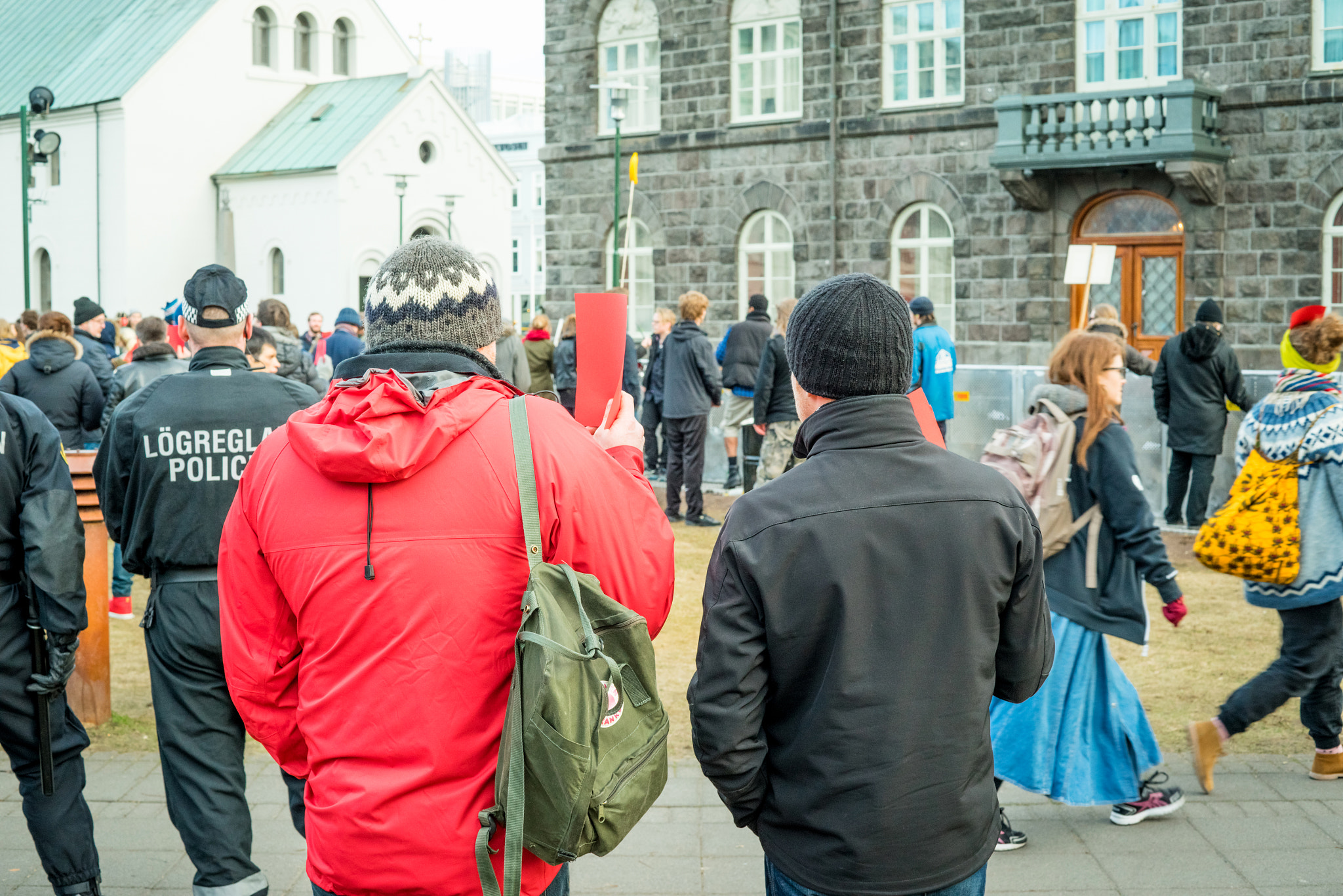 Sony a7R + Sony 50mm F1.4 sample photo. Man showing a red card at a demonstration against the government photography