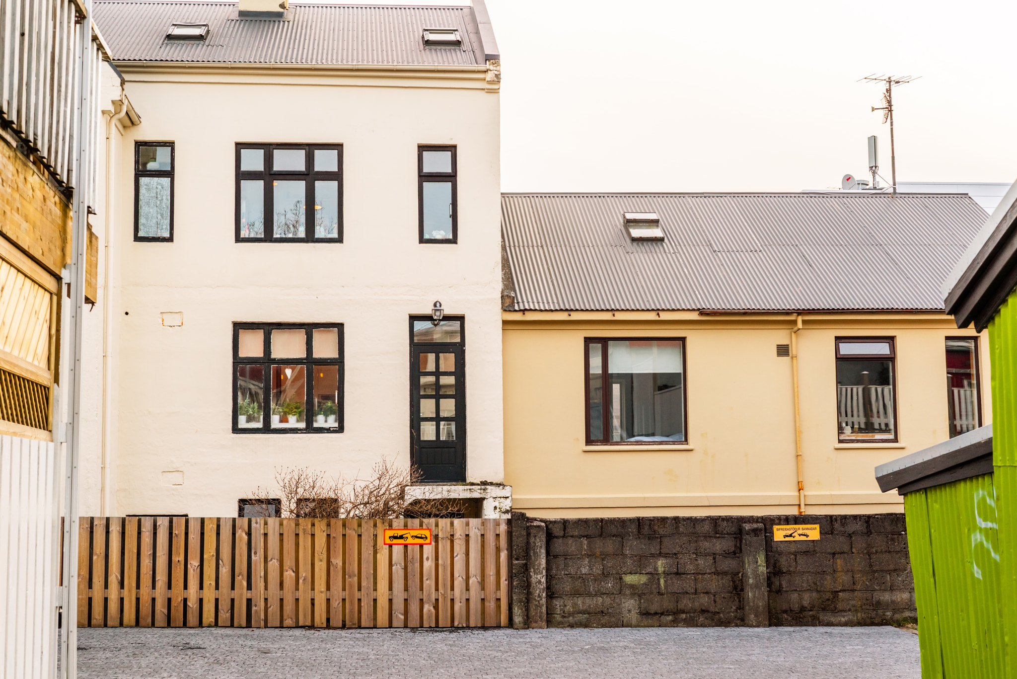 Sony a7R + Sony 50mm F1.4 sample photo. Backyard in reykjavik with no parking signs photography