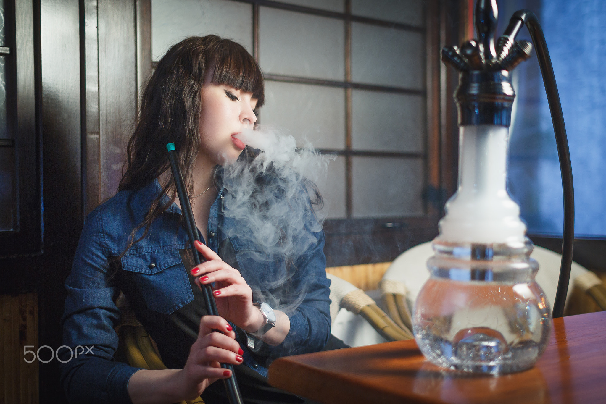 Beautiful young woman with hookah