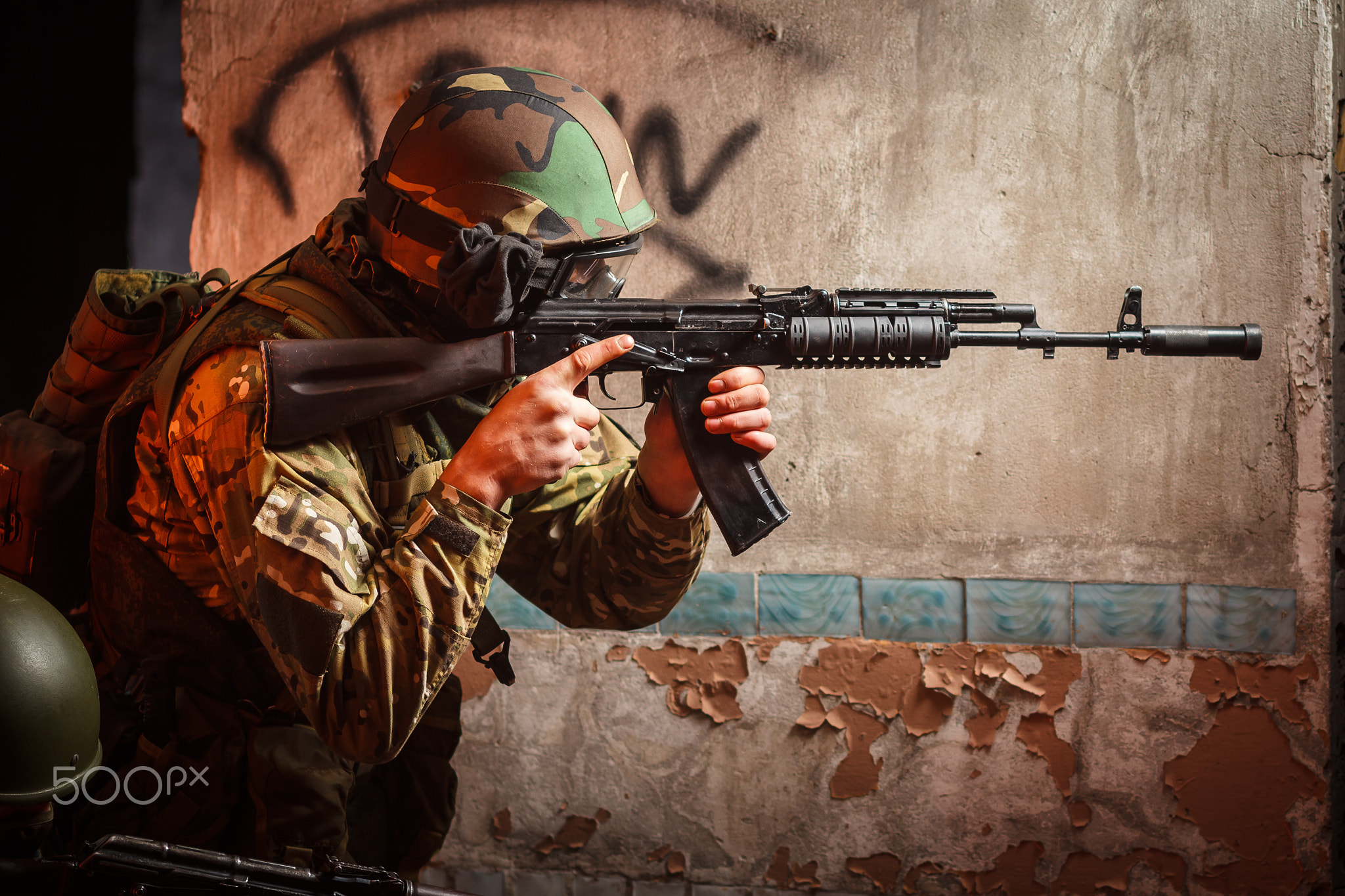 Soldier with the russian machine gun in abandoned building