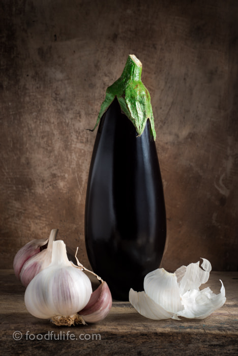 Nikon D800 + AF Nikkor 50mm f/1.8 sample photo. Aubergine with garlic on wood photography