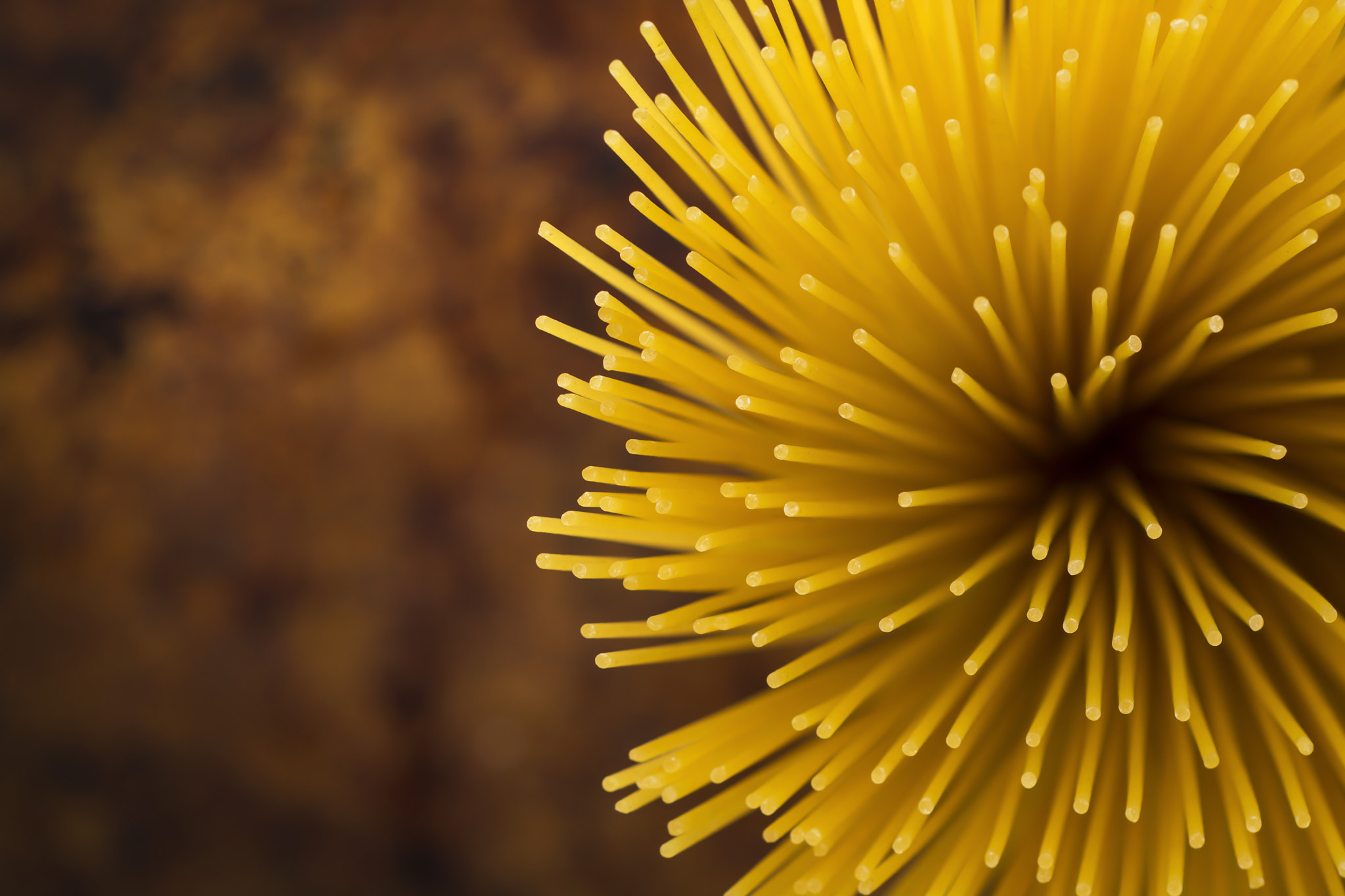 Nikon D7100 + Nikon PC-E Micro-Nikkor 85mm F2.8D Tilt-Shift sample photo. Yellow long spaghetti on a rustic background. photography