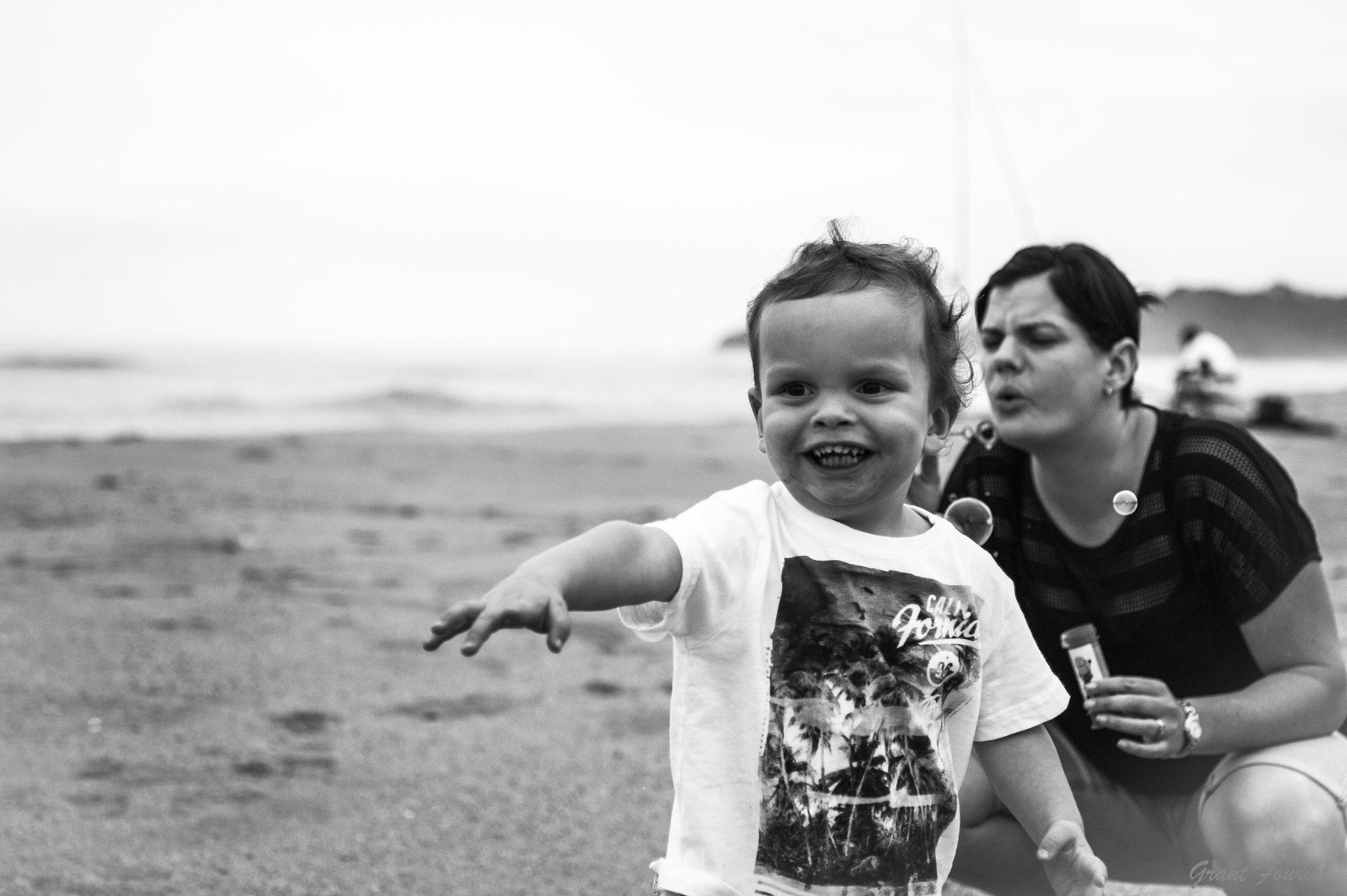 Sony Alpha DSLR-A350 + Sigma 30mm F1.4 EX DC HSM sample photo. Mom and boy having fun on the beach photography