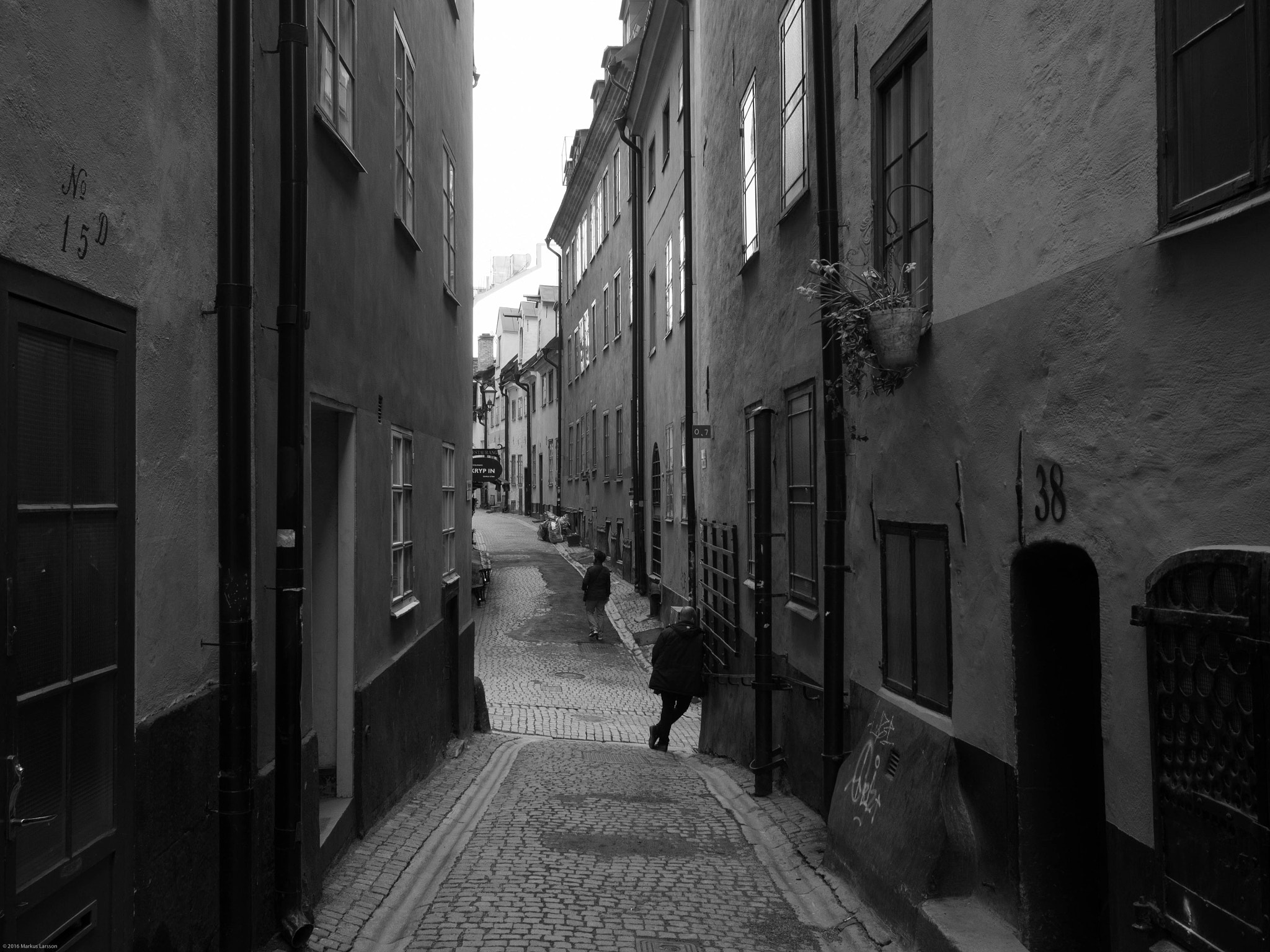 Olympus M.Zuiko Digital 17mm F1.8 sample photo. Man waiting in old town stockholm photography