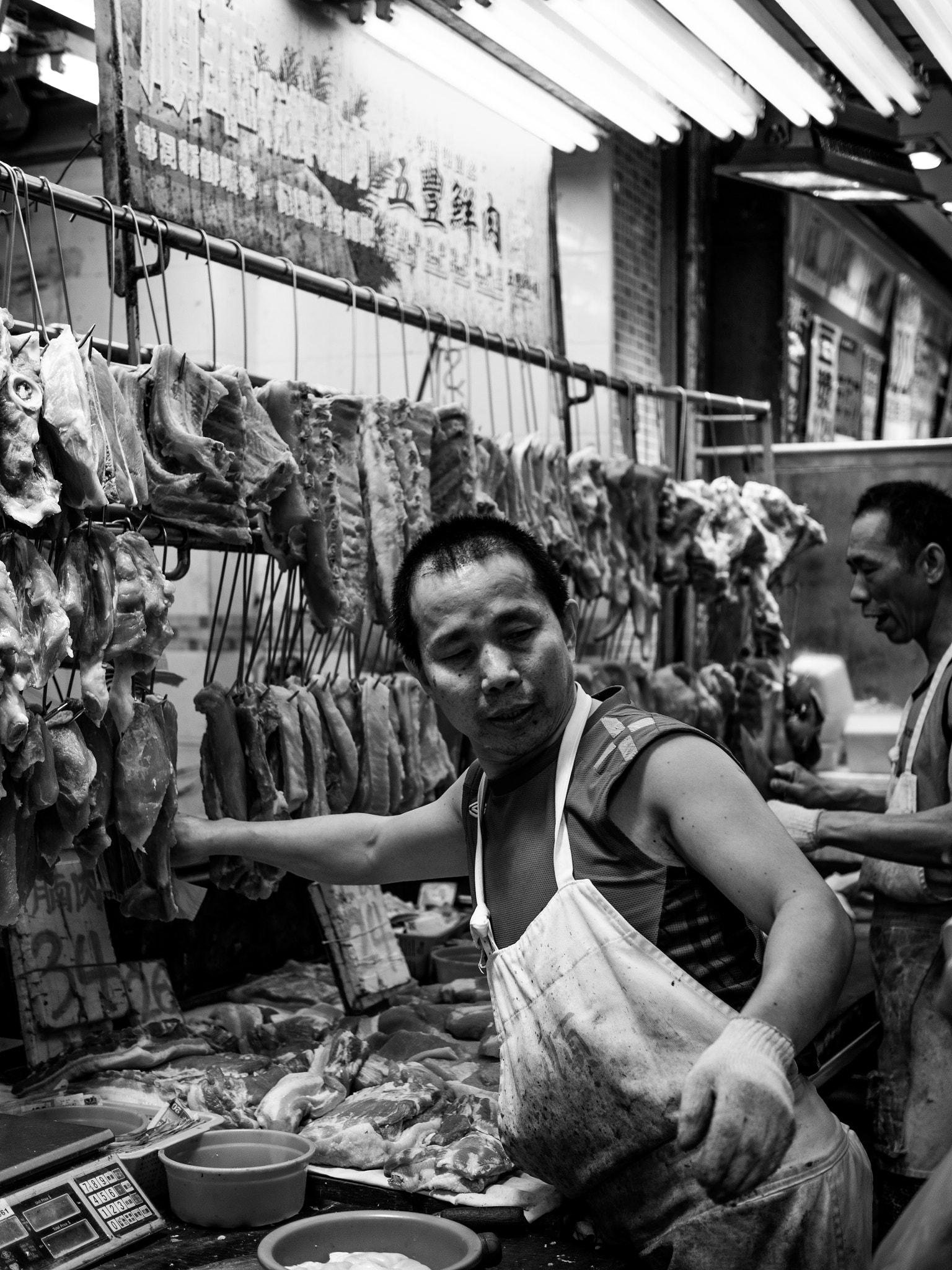 Olympus OM-D E-M5 + Olympus M.Zuiko Digital 25mm F1.8 sample photo. Butcher working at sham shui po, hong kong photography