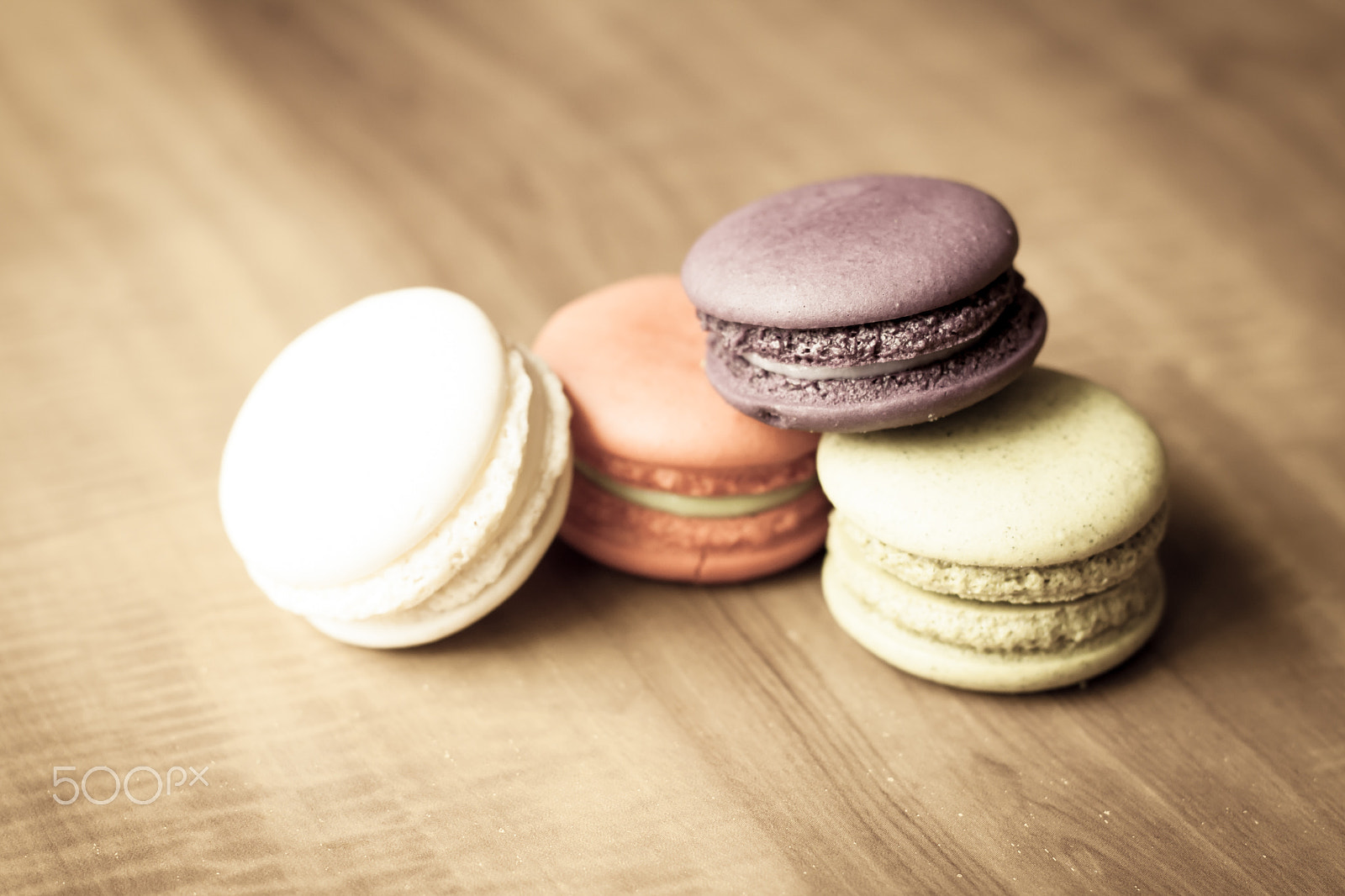 Canon EOS 500D (EOS Rebel T1i / EOS Kiss X3) + Canon EF 50mm F1.8 II sample photo. Colorful french macarons on wooden background in v photography