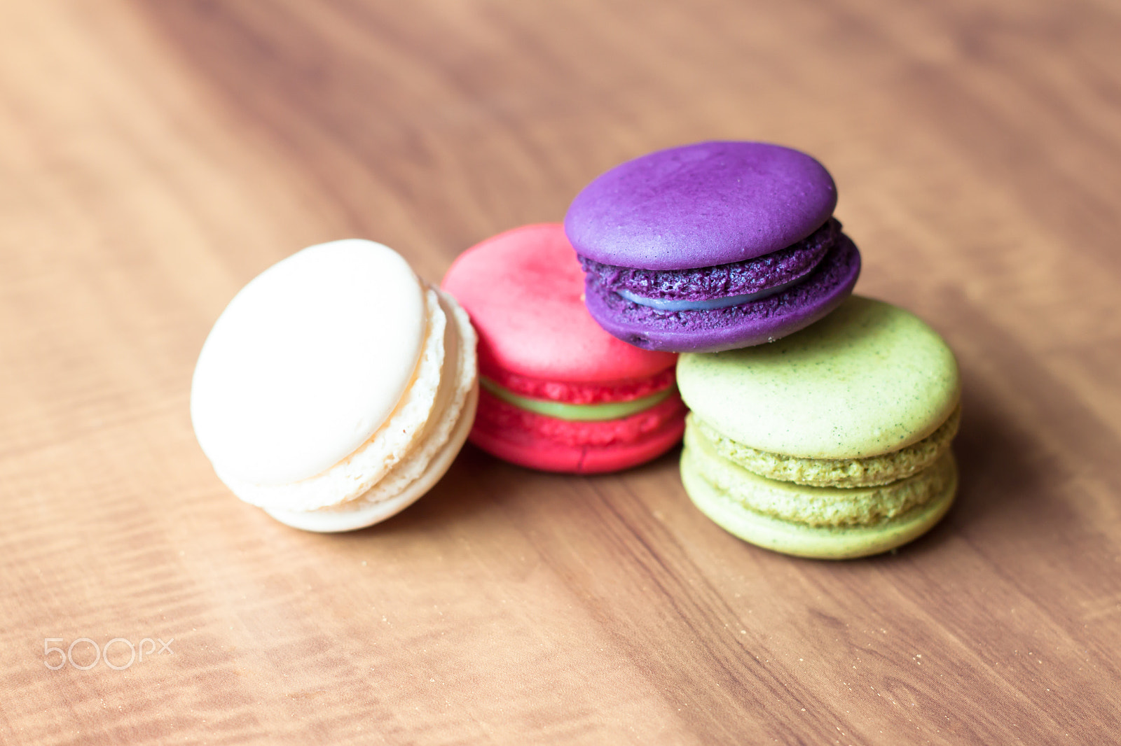 Canon EOS 500D (EOS Rebel T1i / EOS Kiss X3) + Canon EF 50mm F1.8 II sample photo. Colorful french macarons on wooden background. photography