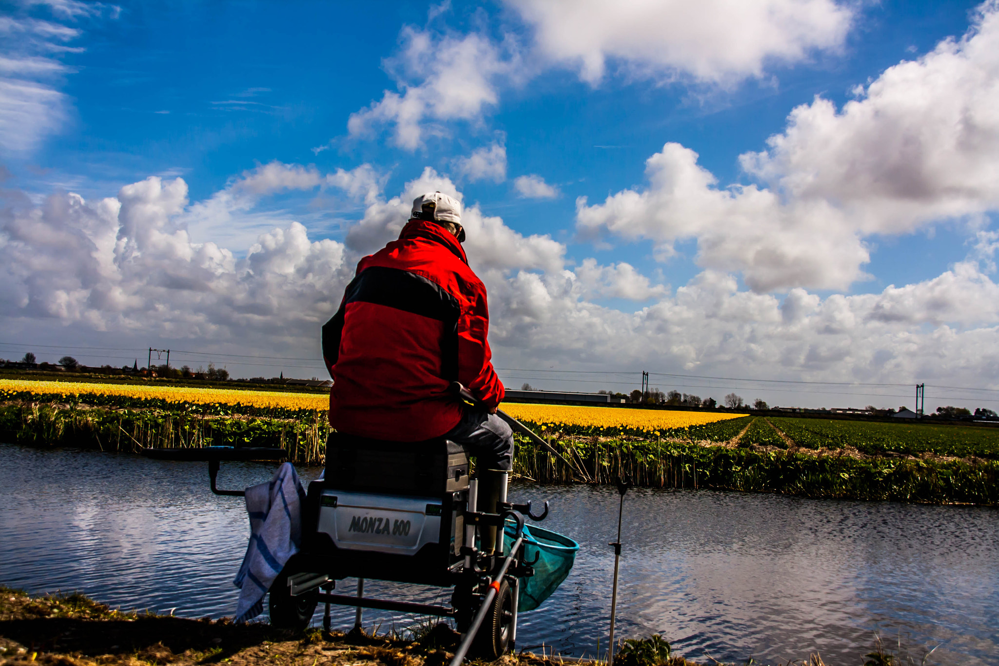 Sigma 18-200mm f/3.5-6.3 DC OS sample photo. Fisherman with flowerfield photography
