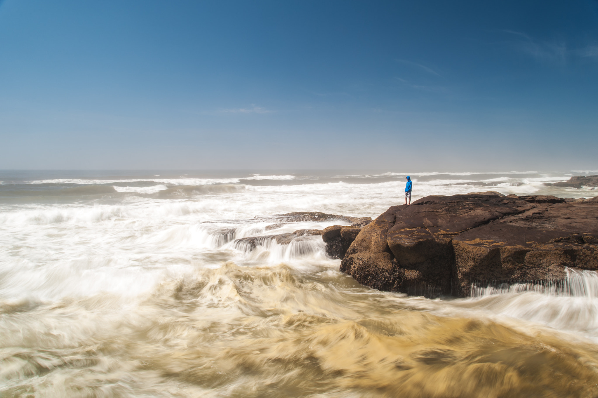 AF Zoom-Nikkor 28-80mm f/3.3-5.6G sample photo. Young boy stands before a violent ocean photography