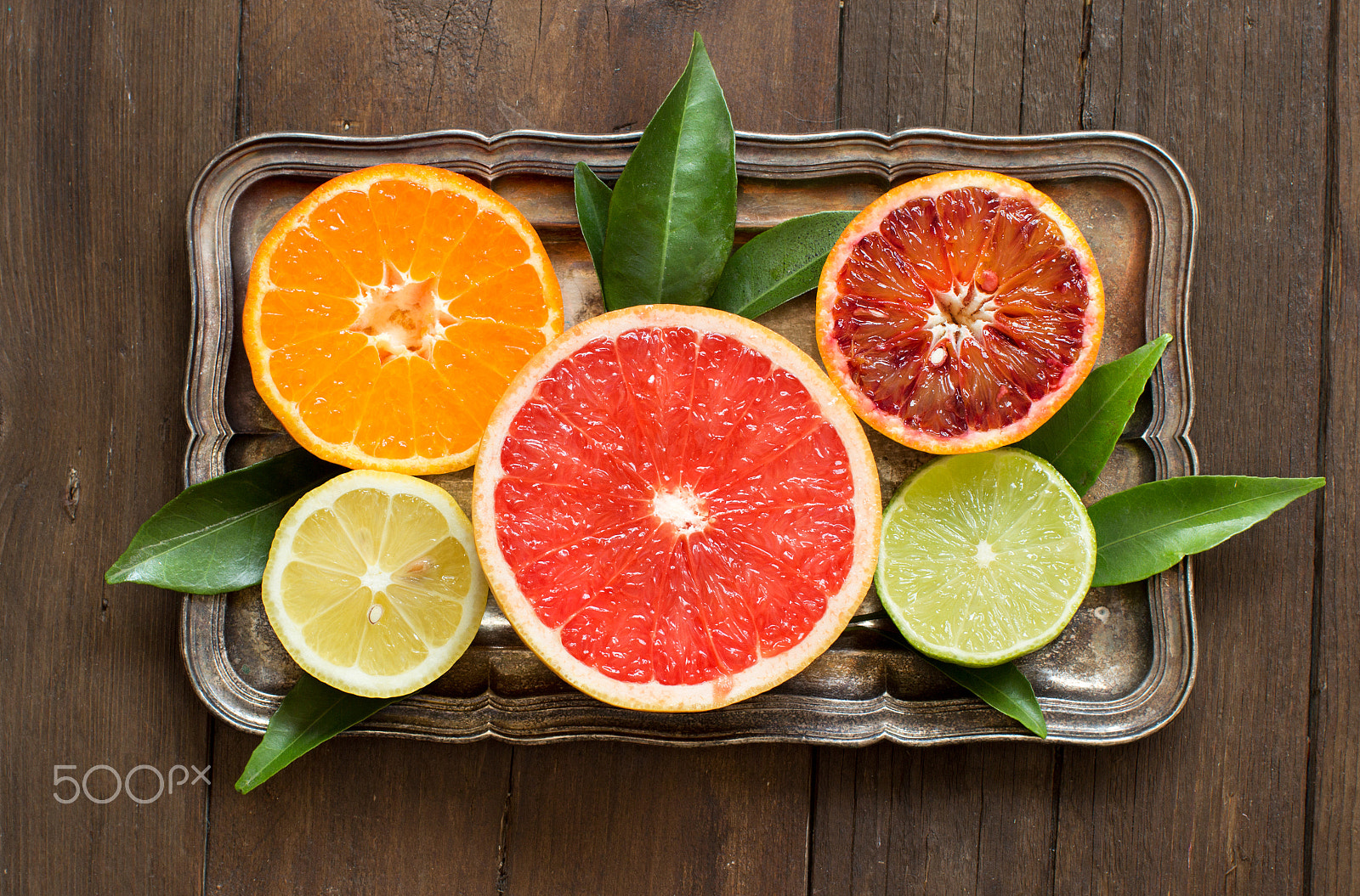 Canon EOS 650D (EOS Rebel T4i / EOS Kiss X6i) + Canon EF 50mm F1.2L USM sample photo. Fresh citrus fruits with leaves on a  wooden table photography