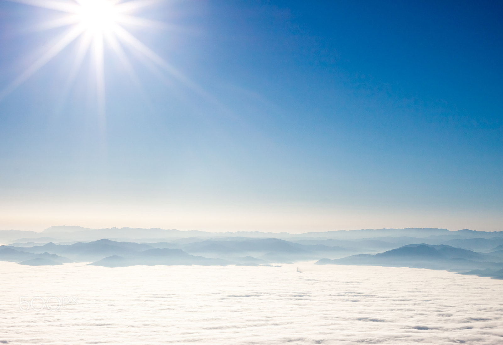 Canon EOS 500D (EOS Rebel T1i / EOS Kiss X3) + Canon EF 40mm F2.8 STM sample photo. View on mountains and sun above clouds photography