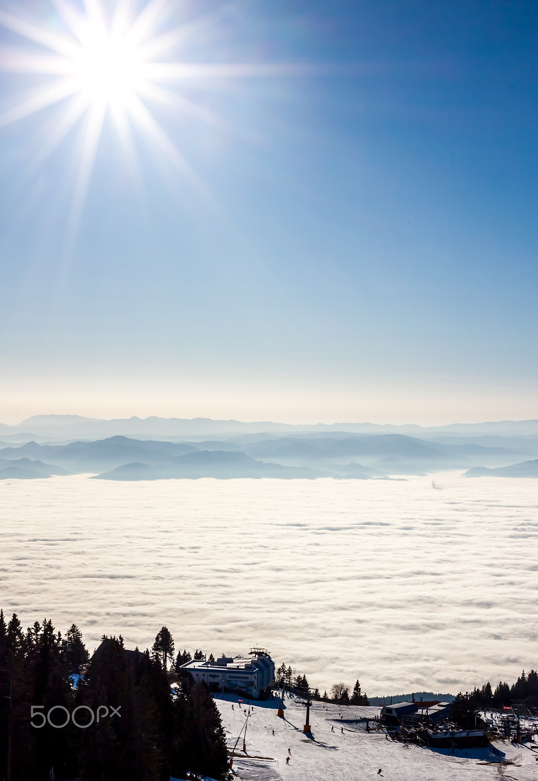 Canon EOS 500D (EOS Rebel T1i / EOS Kiss X3) + Canon EF 40mm F2.8 STM sample photo. View on mountains and sun above clouds photography