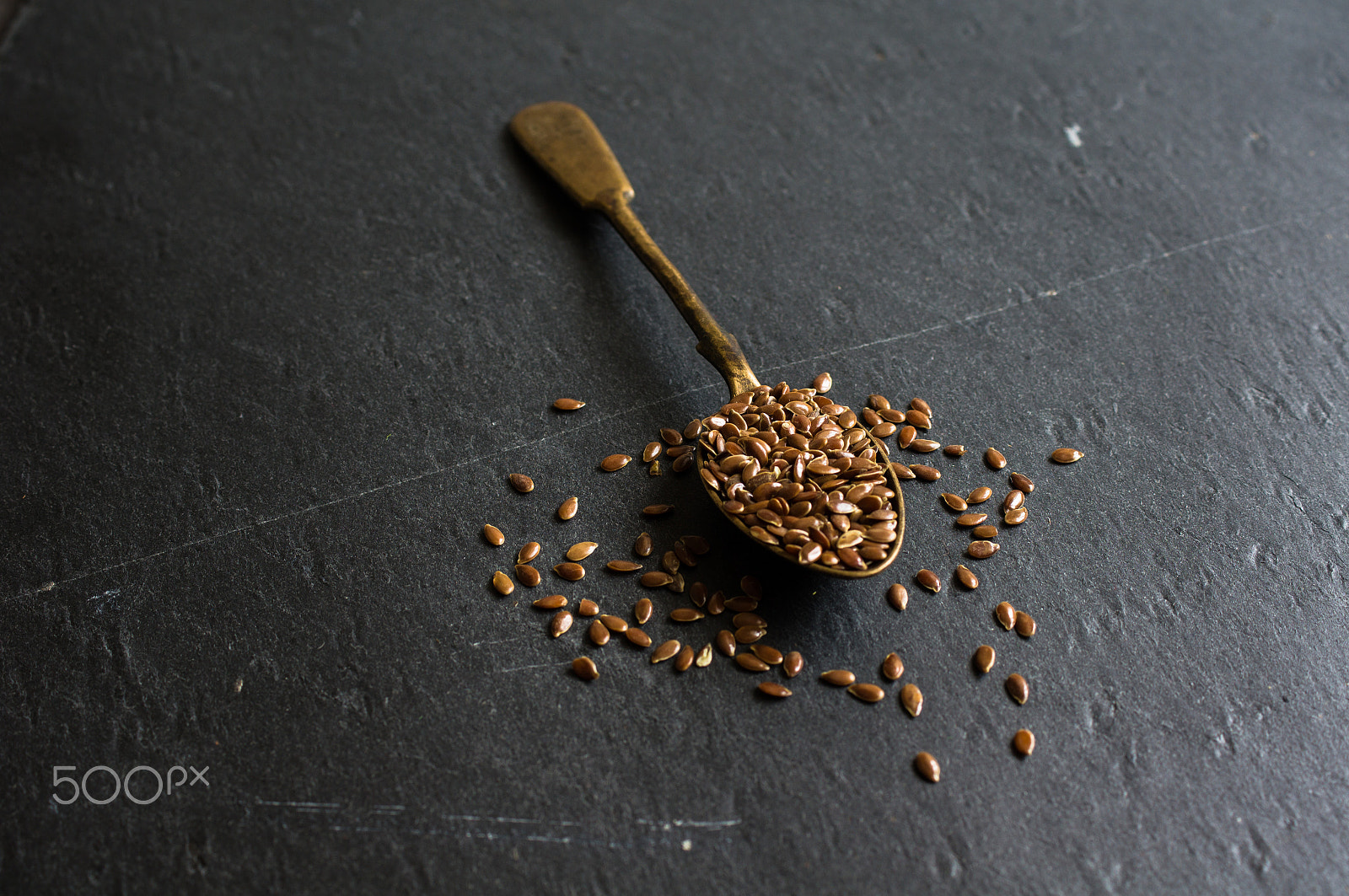 Sony SLT-A55 (SLT-A55V) + Sony DT 30mm F2.8 Macro SAM sample photo. Flax seeds on black board photography