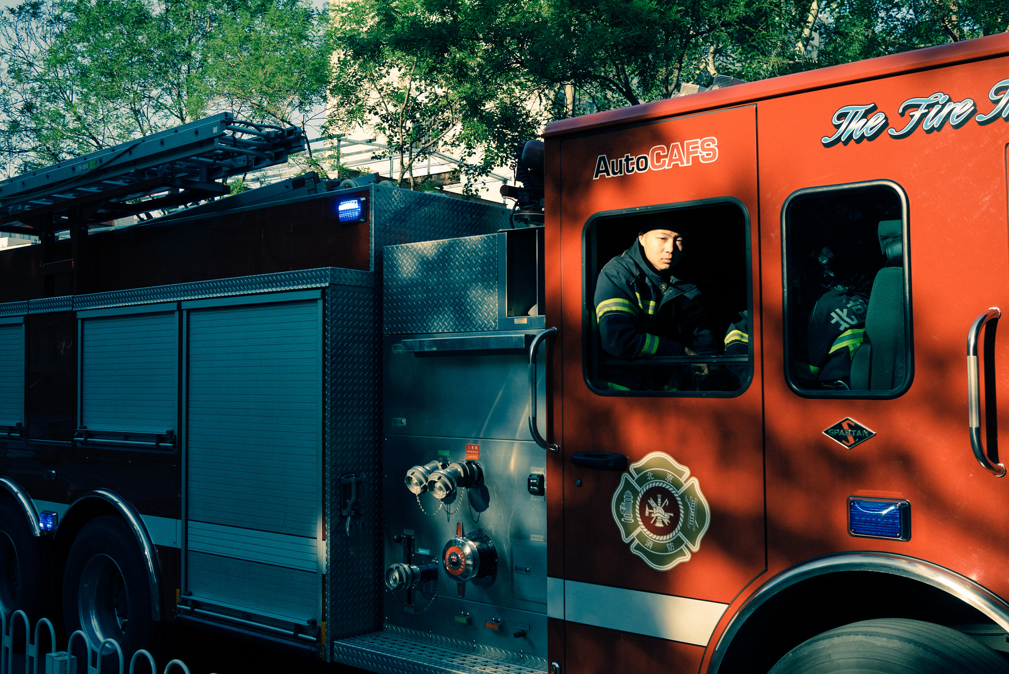 Panasonic DMC-GM1S + LUMIX G 20/F1.7 II sample photo. Young fireman goes for fire alarm photography