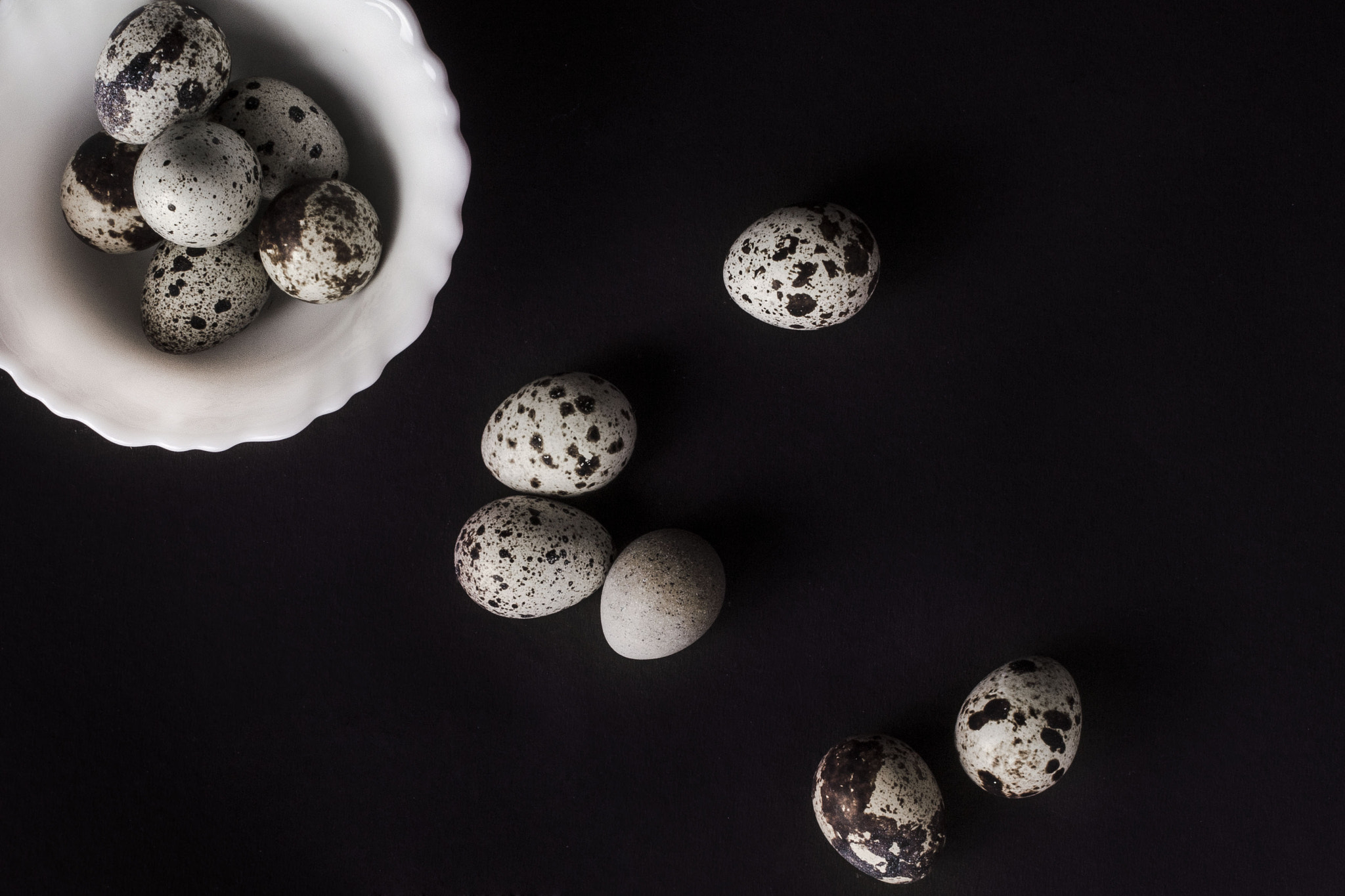 Nikon D7000 + AF Nikkor 35mm f/2 sample photo. Quail eggs in black background photography