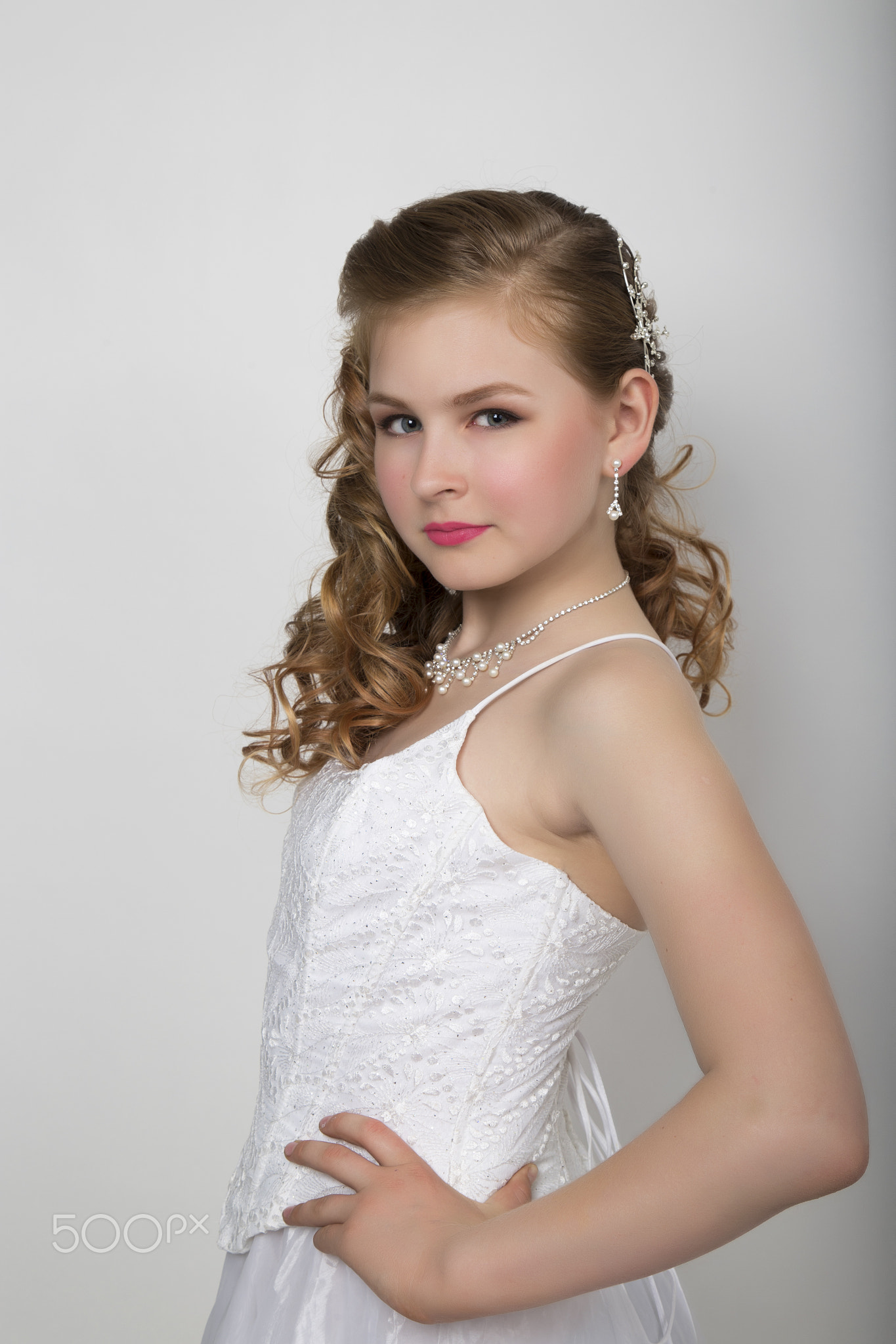 young beautiful bride in a wedding dress with a wedding makeup and hairstyle