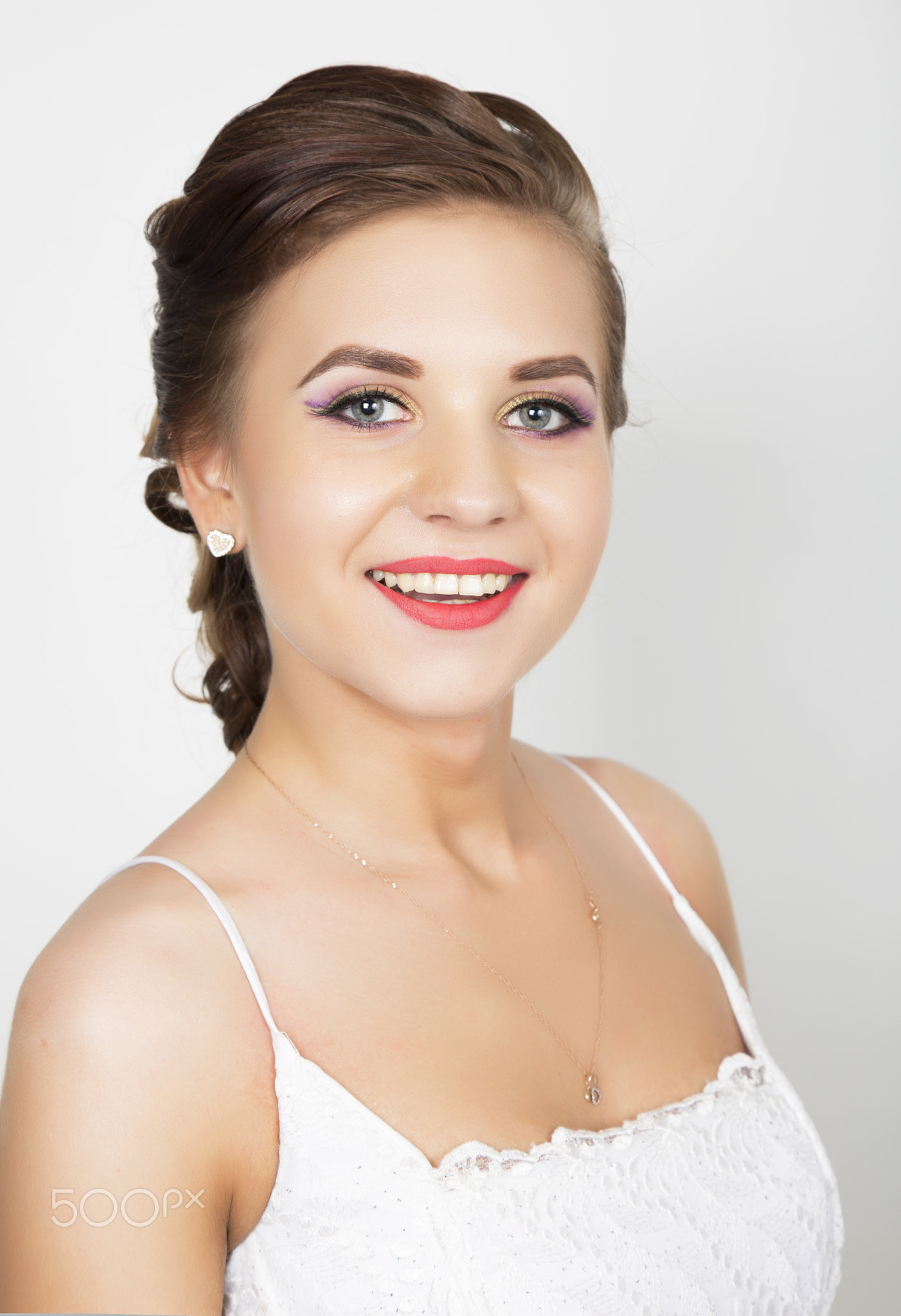 young beautiful bride in a wedding dress with a wedding makeup and hairstyle