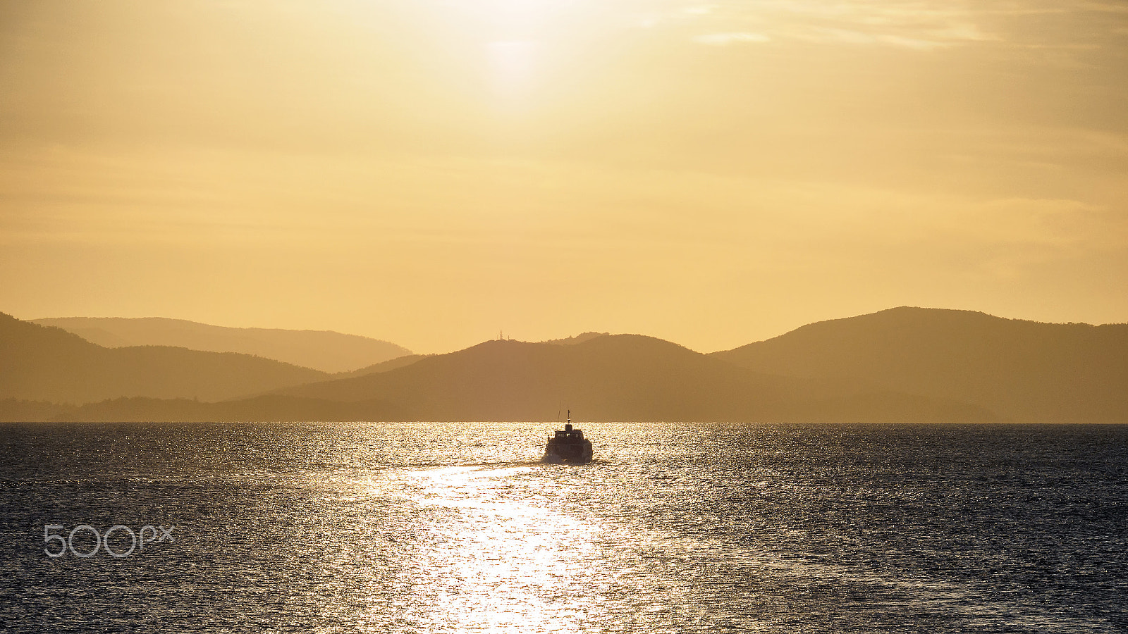 Panasonic Lumix G X Vario 35-100mm F2.8 OIS sample photo. Cruise ship silhouette in sunset light photography