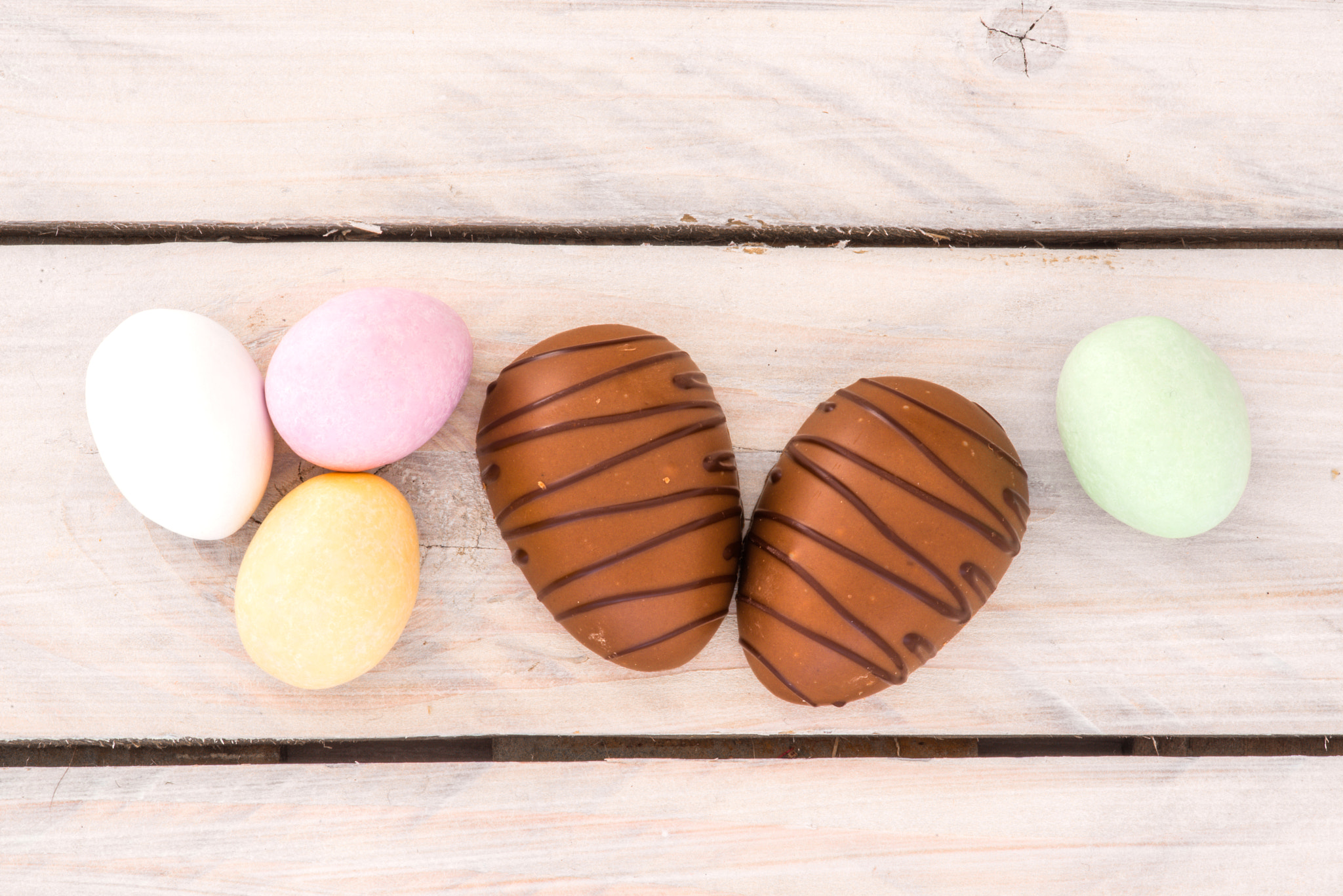 Sony a7R + Minolta AF 100mm F2.8 Macro [New] sample photo. Easter candy eggs on a wooden table photography