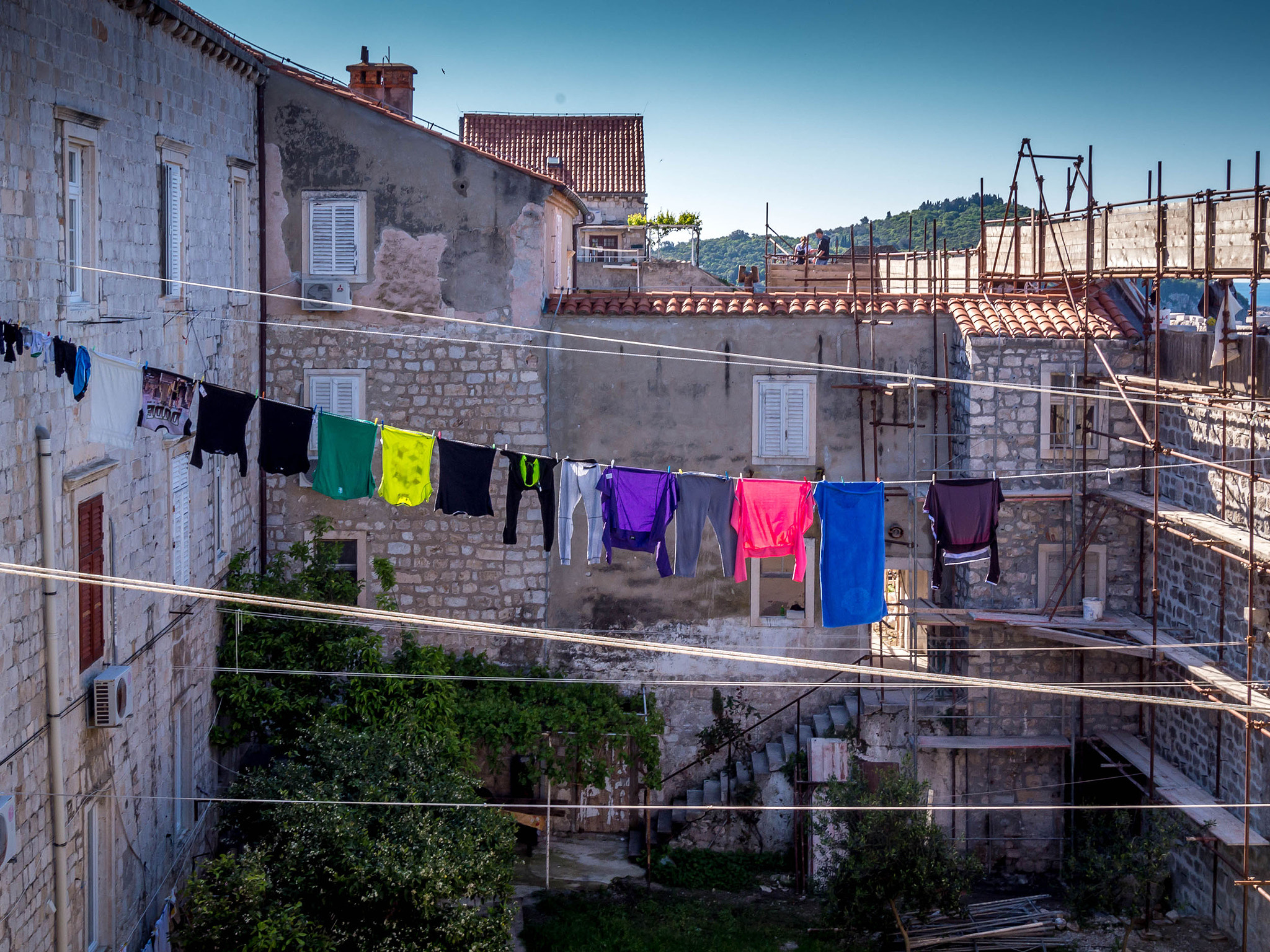 Panasonic Lumix DMC-GH3 sample photo. Castle wall repair with laundry photography