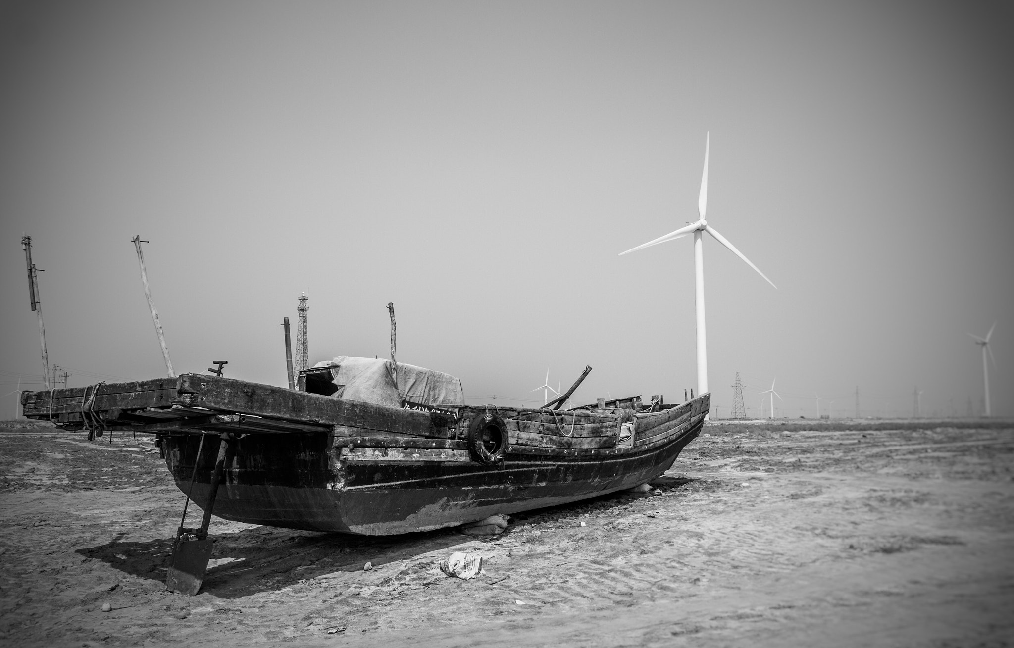 Canon EOS 700D (EOS Rebel T5i / EOS Kiss X7i) + Canon EF-S 18-135mm F3.5-5.6 IS STM sample photo. Worn-out fishing boat and brand new windmills photography