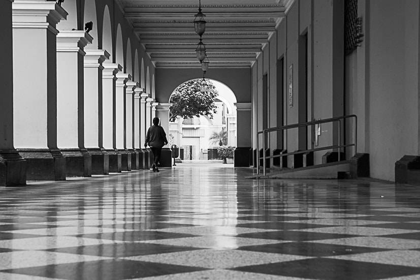 Sony a7R + Sony E 55-210mm F4.5-6.3 OSS sample photo. Woman in corridor photography