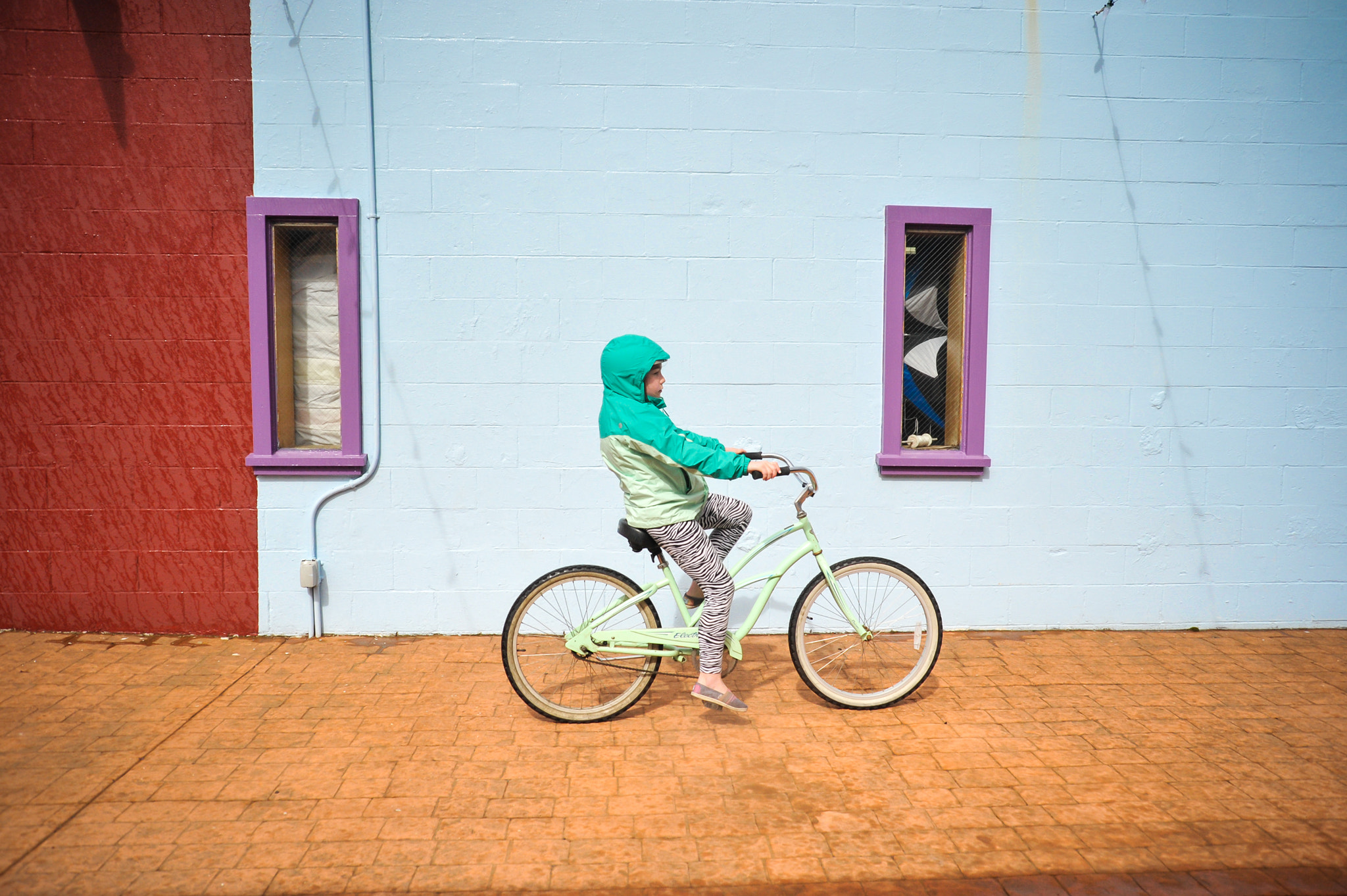 AF Zoom-Nikkor 28-80mm f/3.3-5.6G sample photo. Girl riding bike in colorful urban environment photography