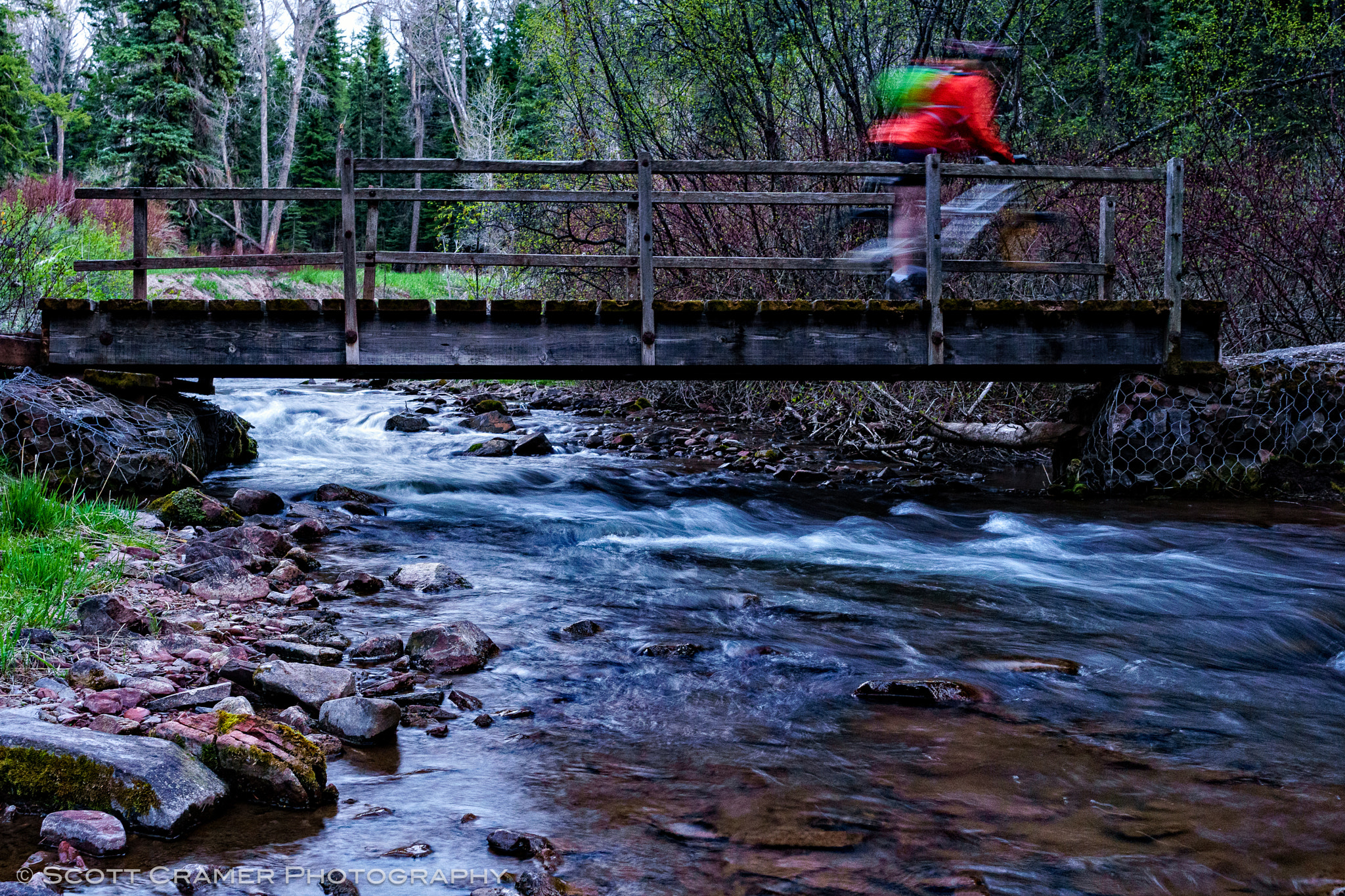 Sony a6300 + Sony FE 28mm F2 sample photo. Mountain biking over scenic bridge crossing creek photography