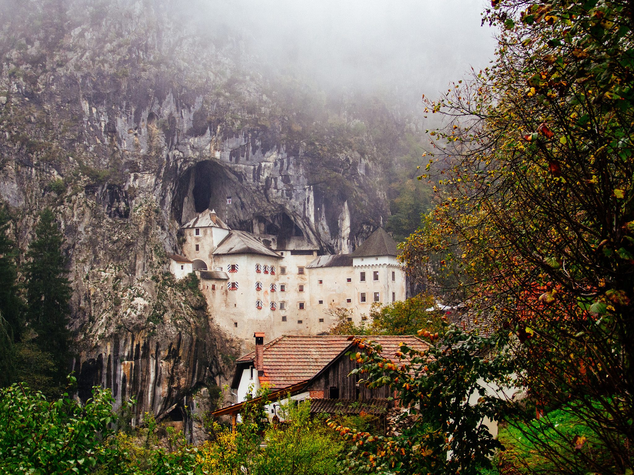 Tamron 14-150mm F3.5-5.8 Di III sample photo. Predjama castle in the autumn photography