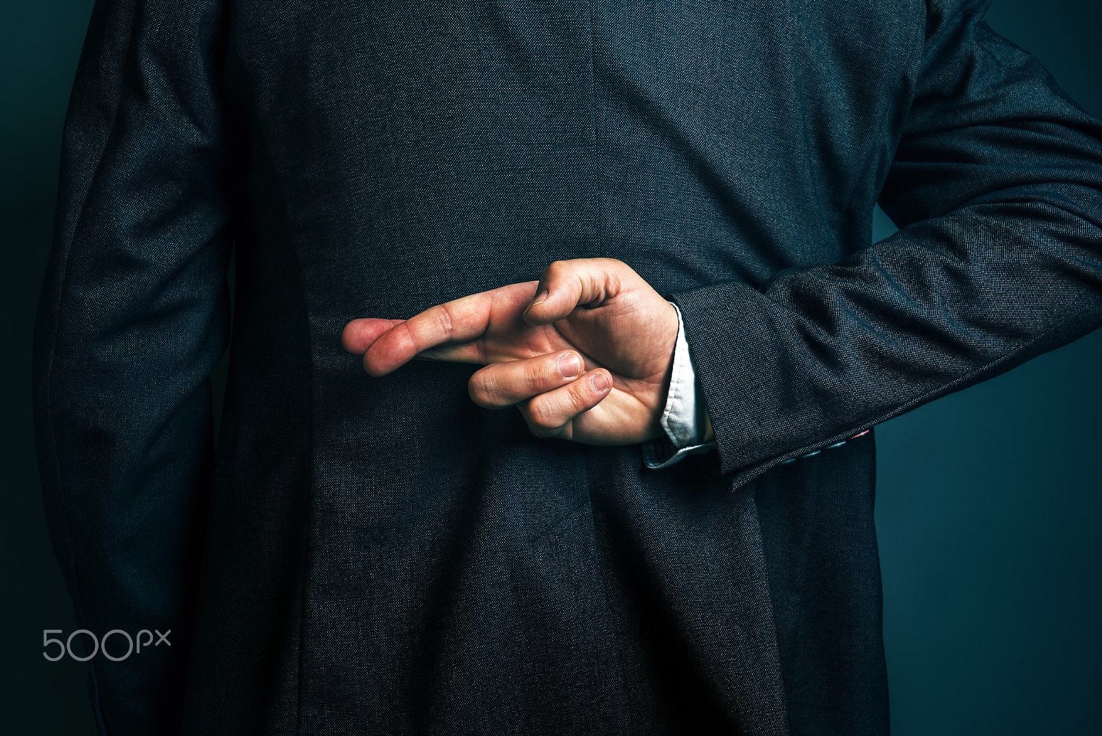 Tamron SP 15-30mm F2.8 Di VC USD sample photo. Lying businessman holding fingers crossed behind his back photography