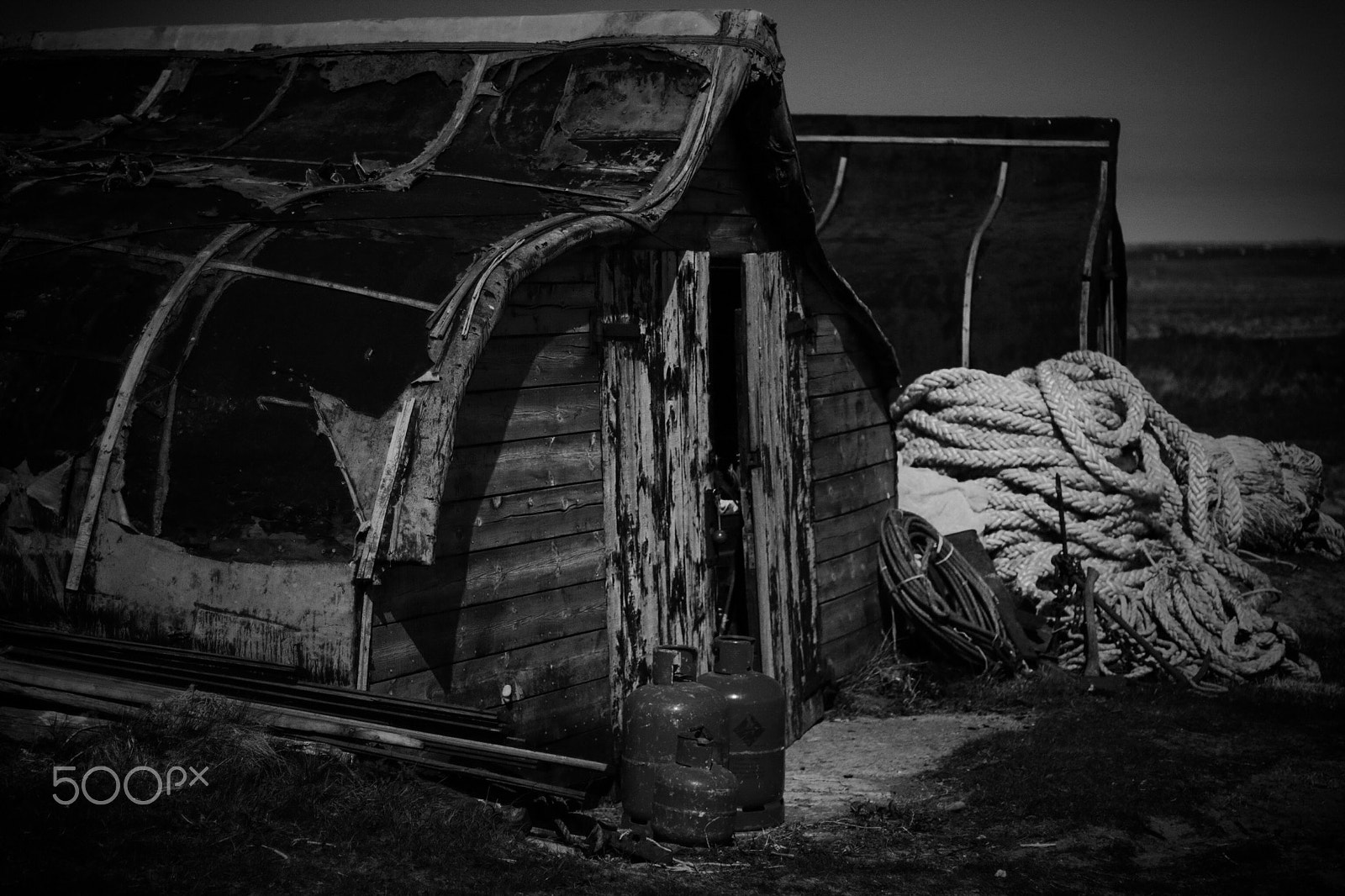Canon EOS 750D (EOS Rebel T6i / EOS Kiss X8i) + Canon EF 50mm F1.4 USM sample photo. Lindisfarne black & white boat huts photography