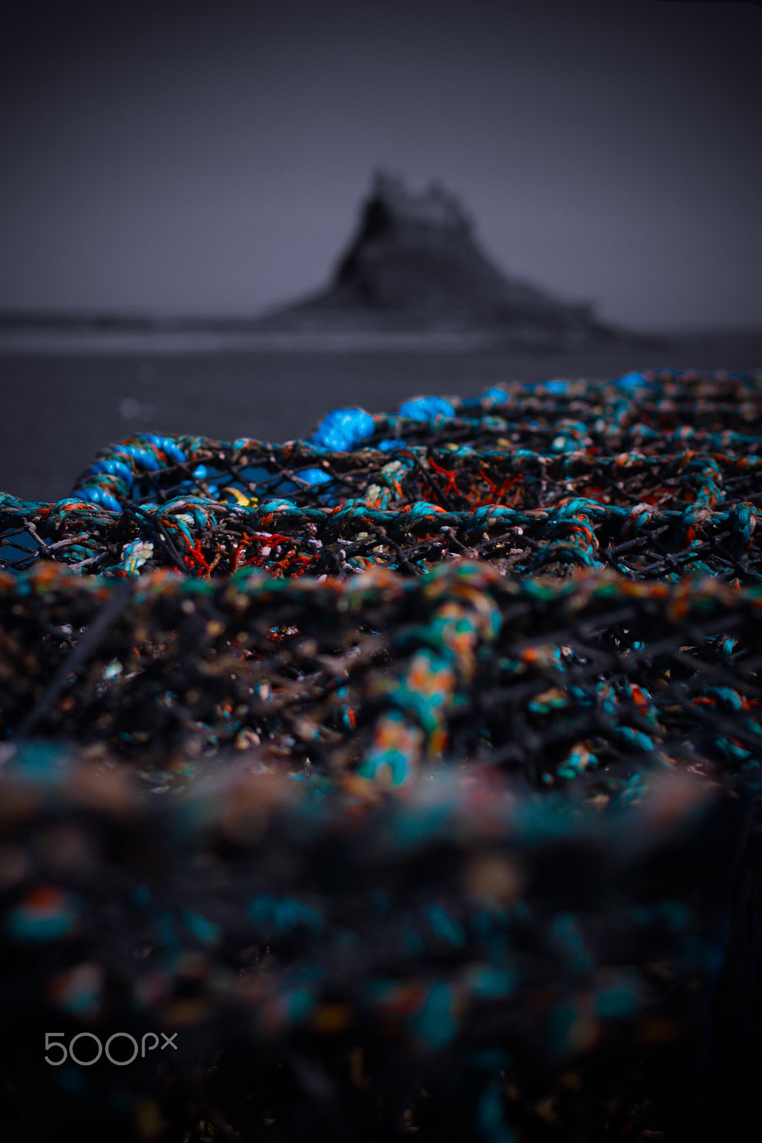 Canon EOS 750D (EOS Rebel T6i / EOS Kiss X8i) + Canon EF 50mm F1.4 USM sample photo. Lindisfarne lobster pots and castle photography