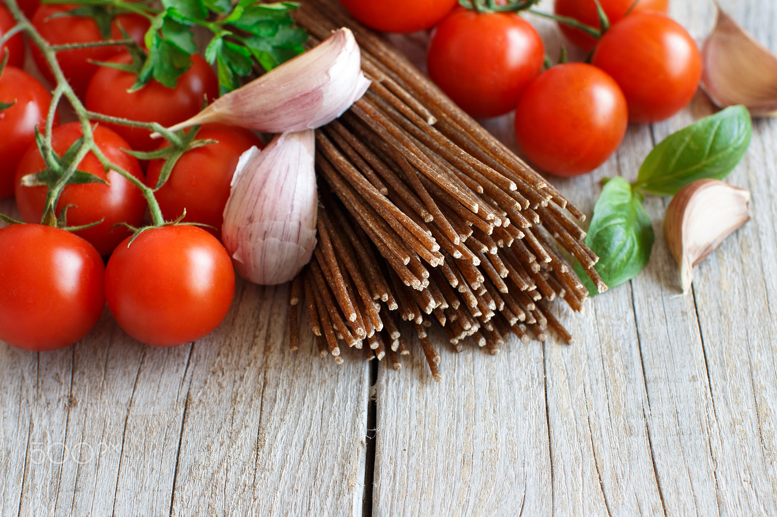 Canon EOS 650D (EOS Rebel T4i / EOS Kiss X6i) + Canon EF 50mm F1.2L USM sample photo. Wholegrain rye spaghetti, tomatoes and herbs photography