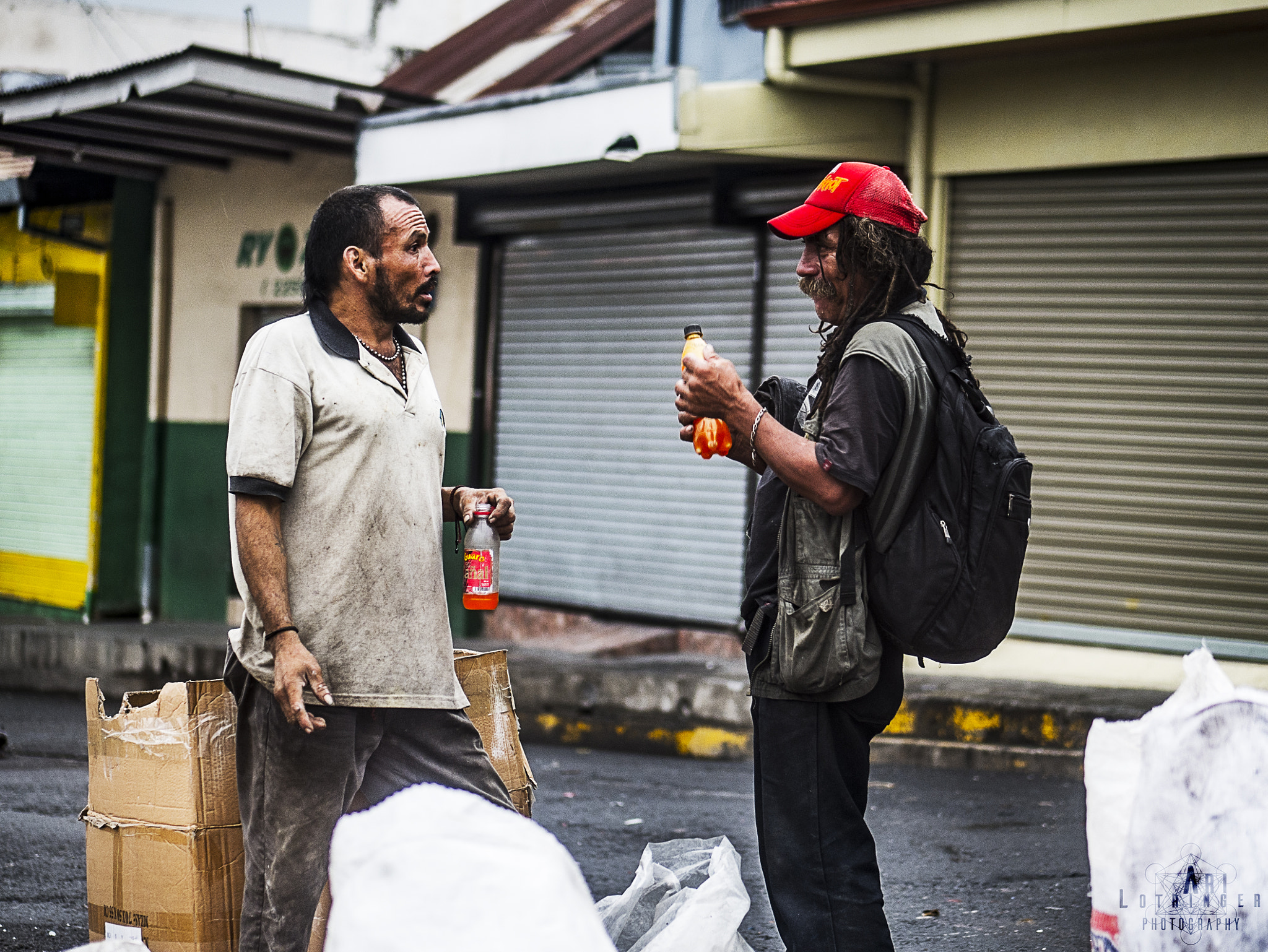 Panasonic Lumix G 42.5mm F1.7 ASPH Power OIS sample photo. A street conversation... photography