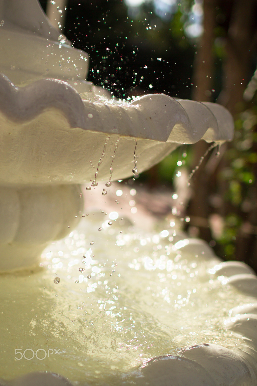 Canon EOS 7D + Canon EF 35mm F1.4L USM sample photo. Close-up of an old stone fountain with dripping water and blurred background photography