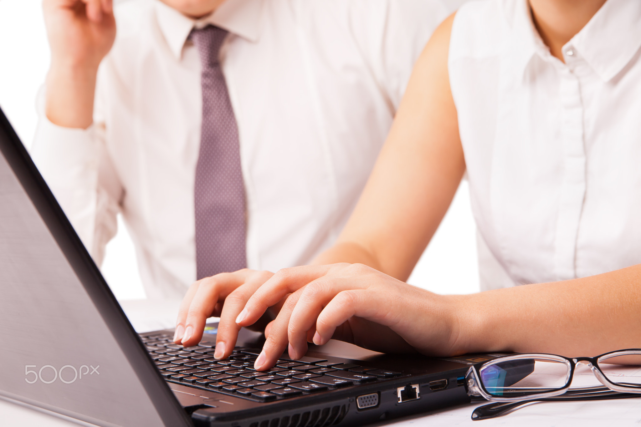 Businessman and businesswoman working on laptop isolated