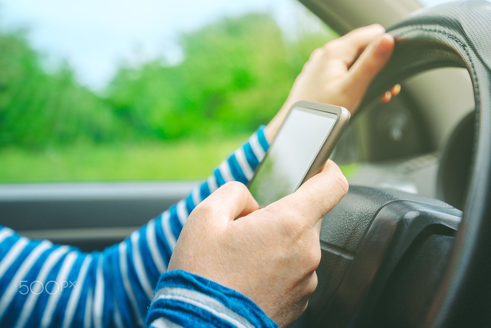 Tamron SP 15-30mm F2.8 Di VC USD sample photo. Female driving car and texting sms message on smartphone photography