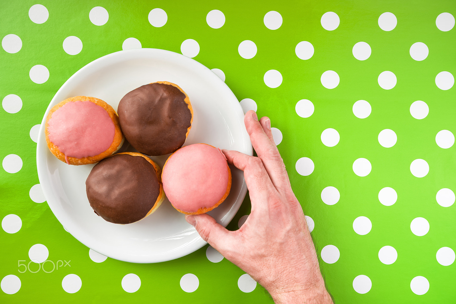 Tamron SP 15-30mm F2.8 Di VC USD sample photo. Hand picking donut with sweet strawberry topping from a plate photography