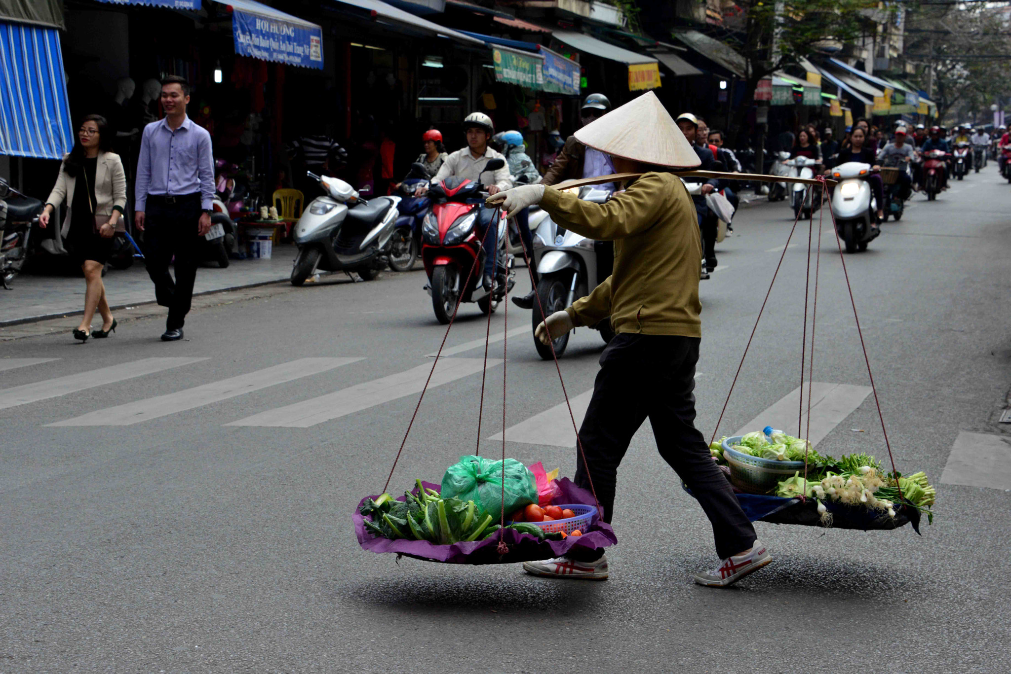 with pole and basquets in the streets of Hanoi