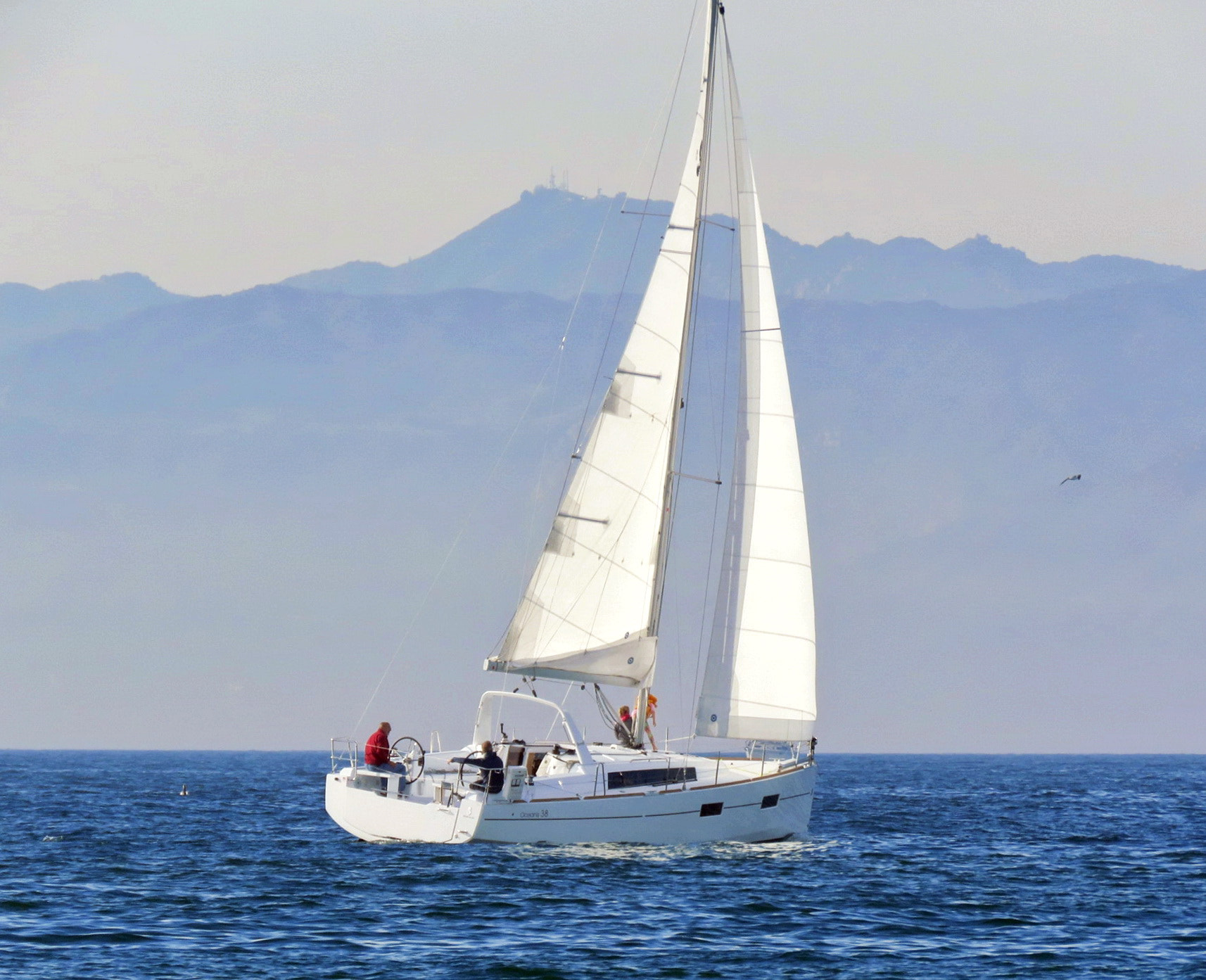 Canon PowerShot SX60 HS + 3.8 - 247.0 mm sample photo. Sailing boat crossing pacific ocean waves three photography