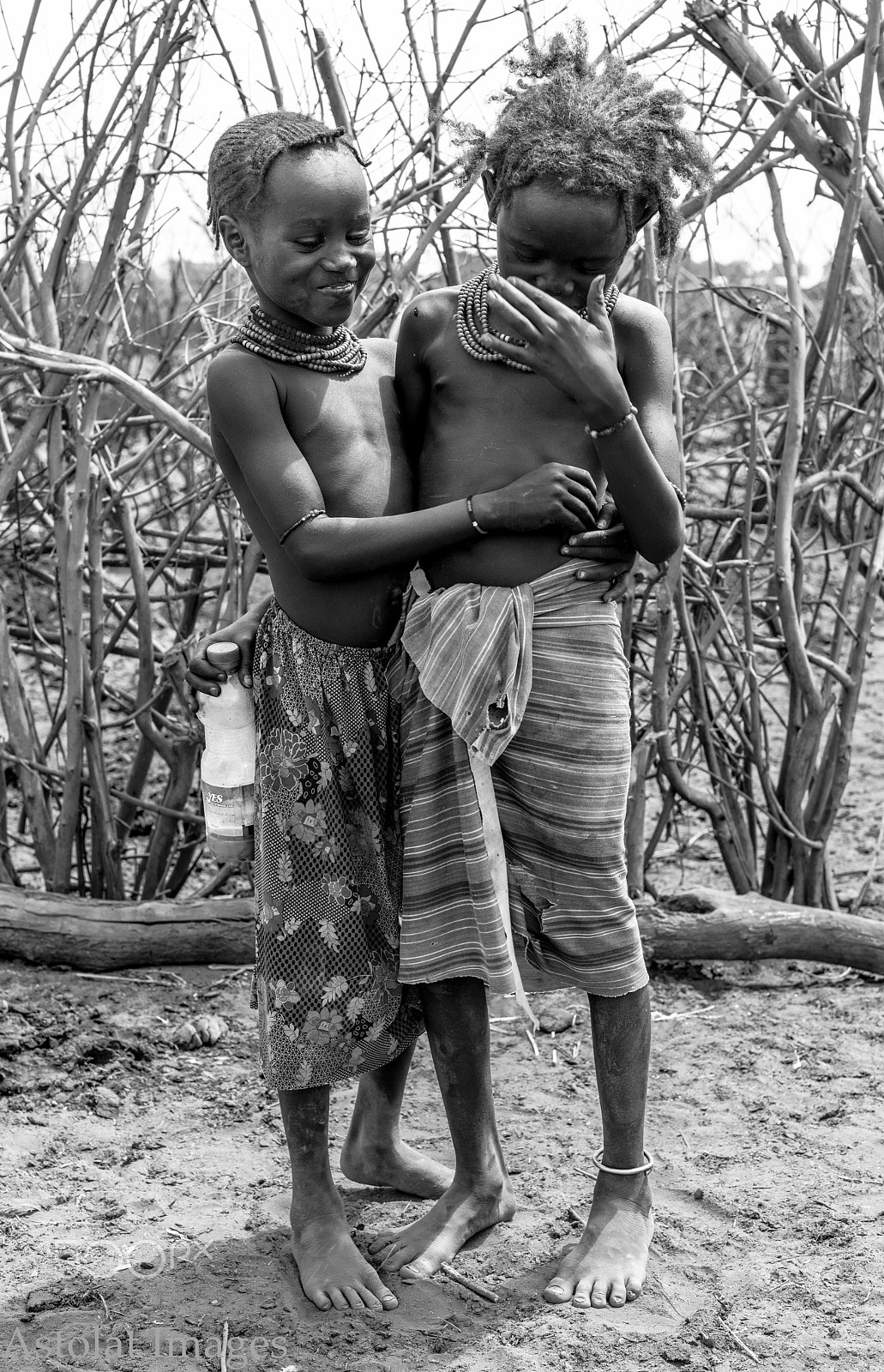 E 50mm F2 sample photo. Dessenech siblings sharing a joke photography