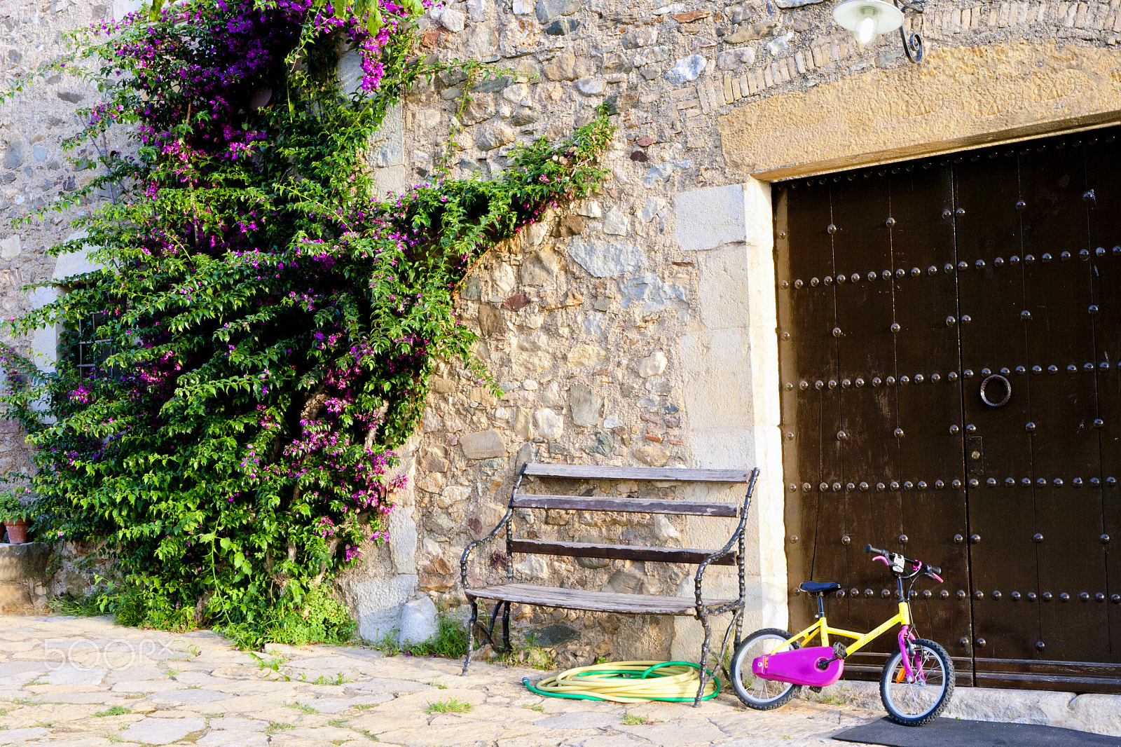 Canon EF 16-35mm F2.8L II USM sample photo. Pink and yellow bicycle and old doors photography