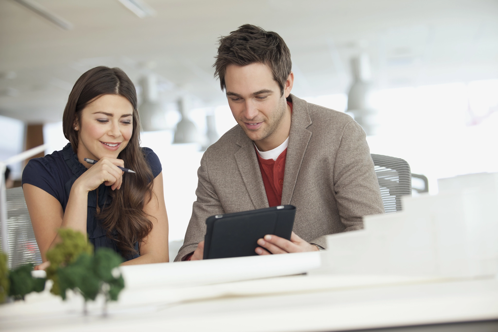 coworkers reviewing architectural plans