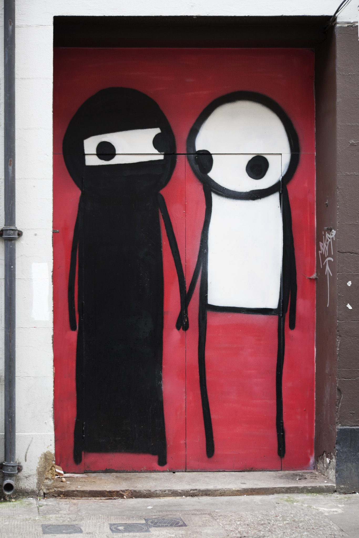 Canon EOS 5D Mark II + Sigma 70-300mm F4-5.6 APO DG Macro sample photo. London - april 11, 2015. street art by stik in a doorway at shoreditch in the borough of tower... photography