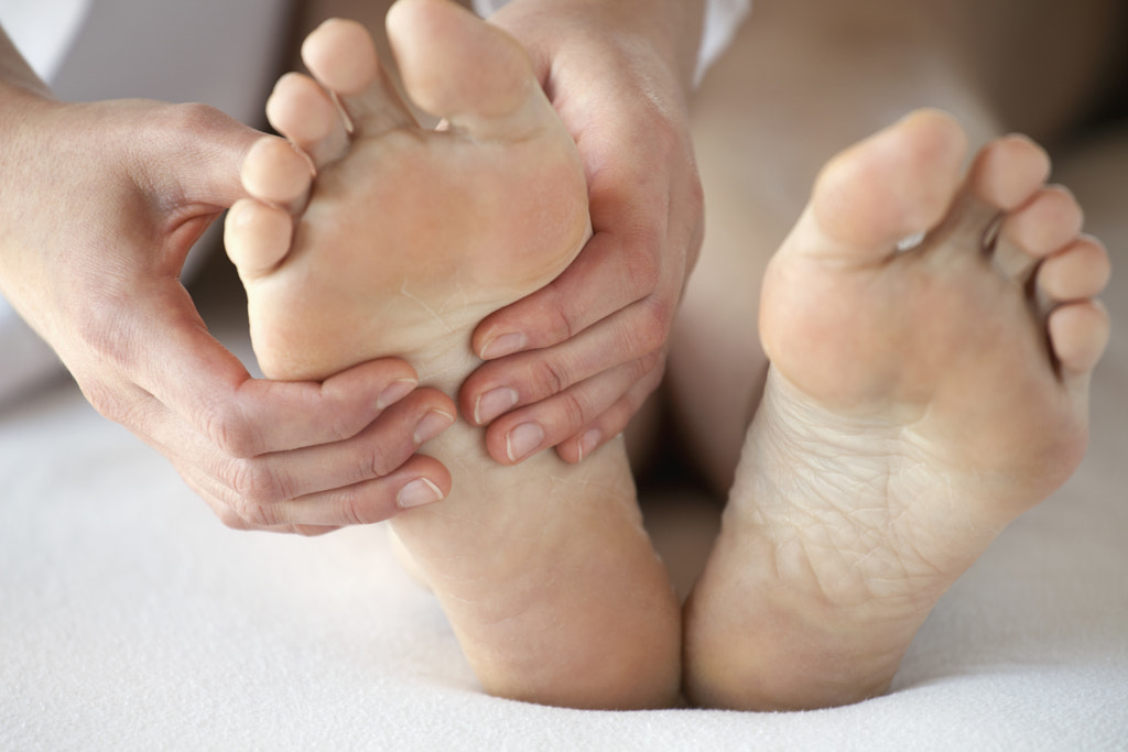 closeup of feet being massaged by Hero Images on 500px.com