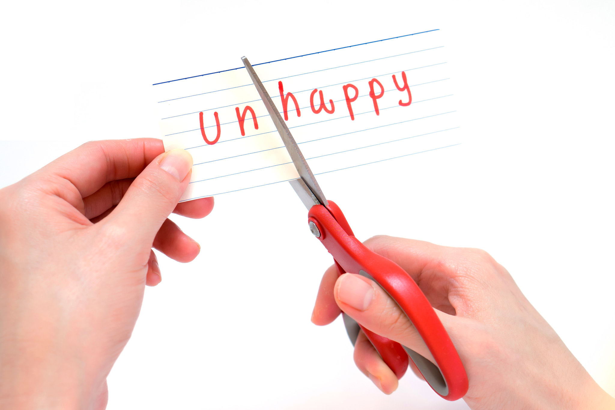 Sony a7 + E 50mm F1.8 OSS sample photo. Female using scissors to remove the word unhappy to read happy c photography