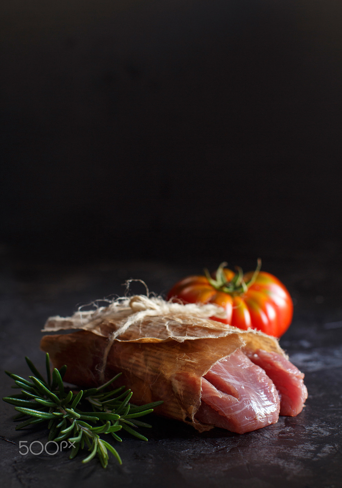 Canon EOS 650D (EOS Rebel T4i / EOS Kiss X6i) + Canon EF 50mm F1.2L USM sample photo. Slice of raw turkey steak with rosemary and tomatoes photography