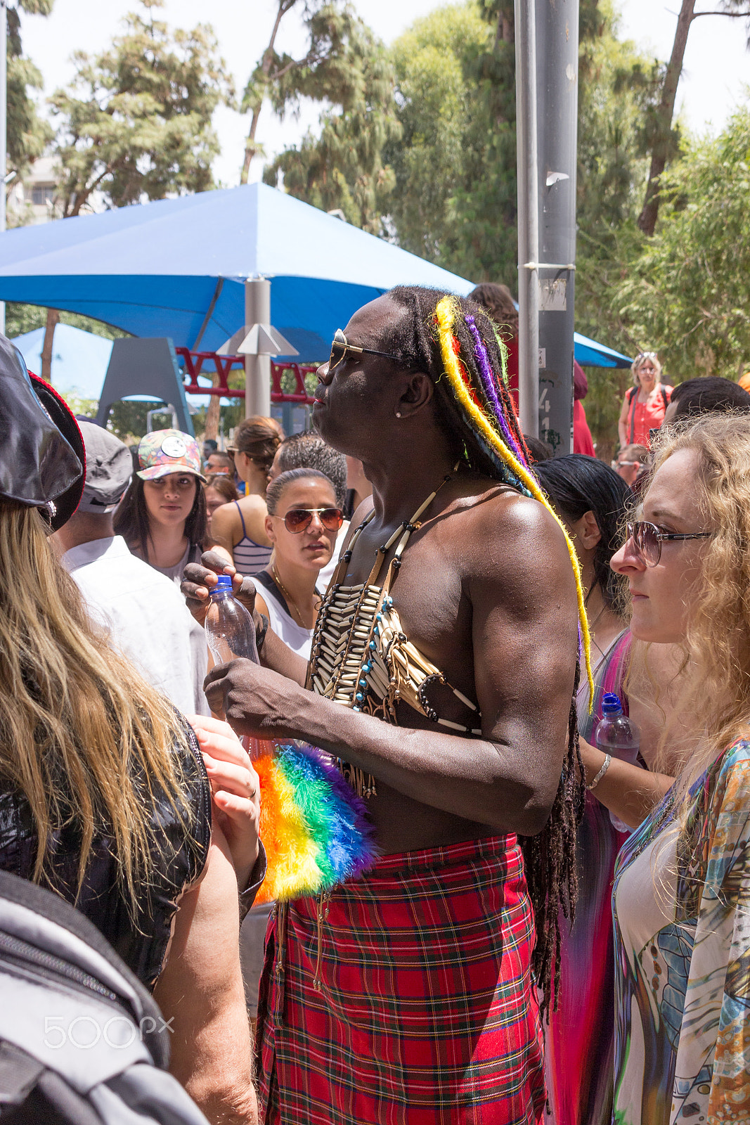 Canon EF 75-300mm F4.0-5.6 IS USM sample photo. Member of pride parade surrounded by other people photography