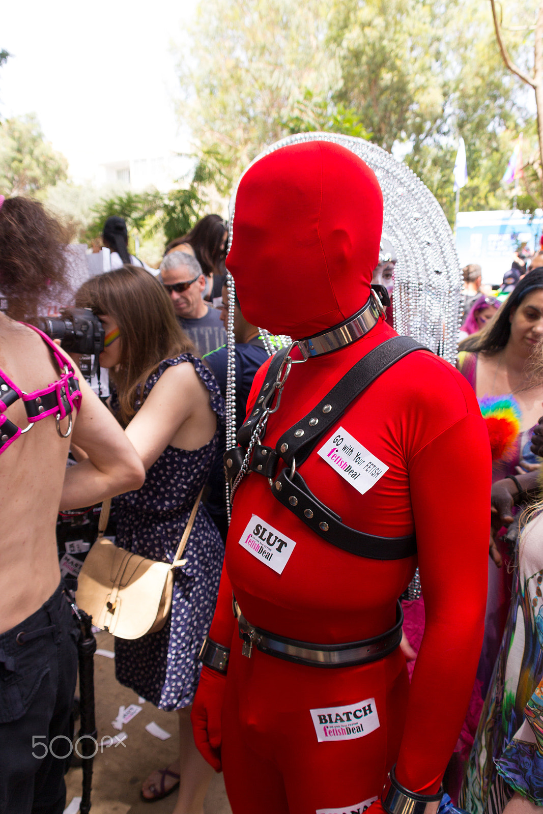 Canon EF 75-300mm F4.0-5.6 IS USM sample photo. Members of the pride parade surrounded by other people photography