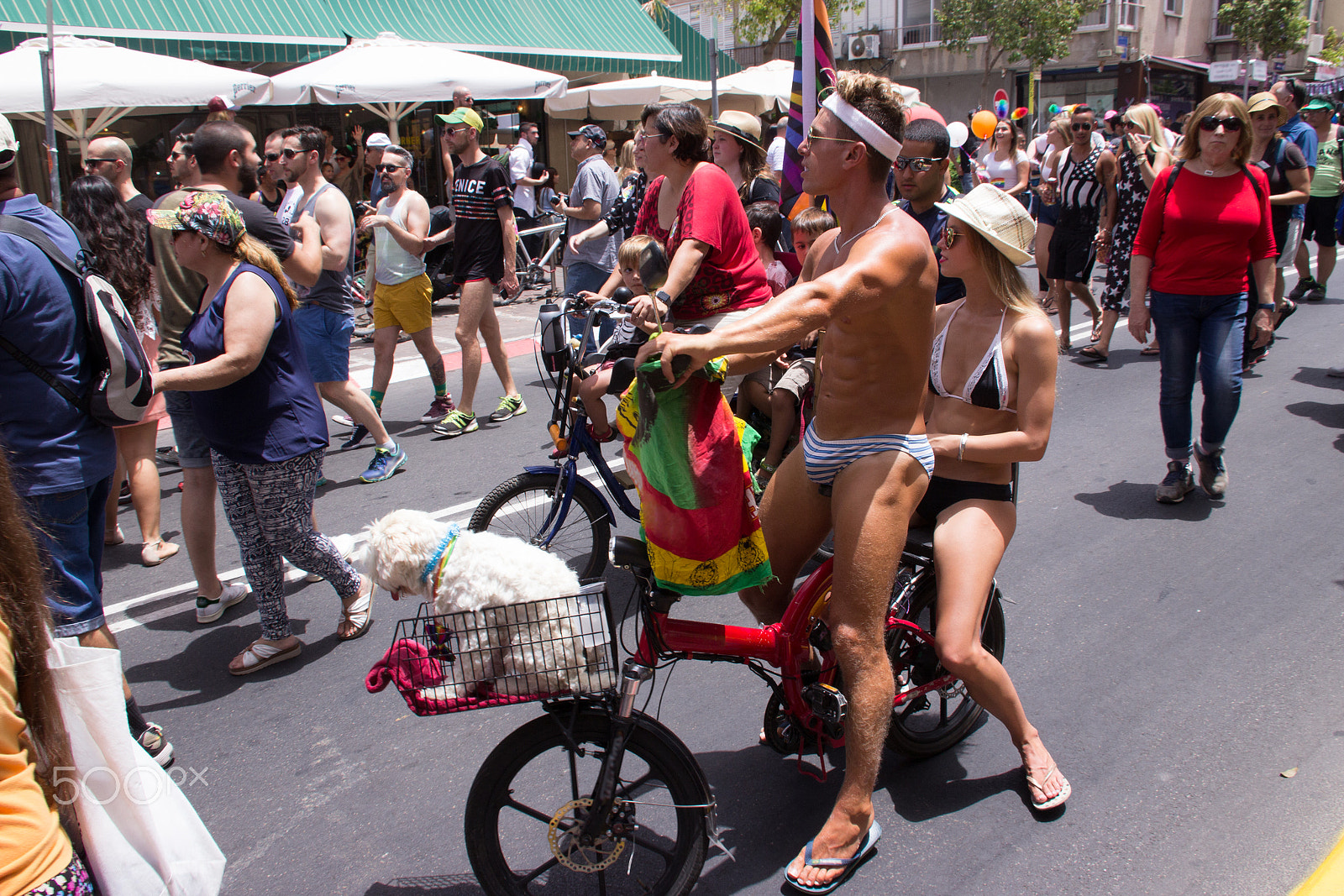 Canon EF 75-300mm F4.0-5.6 IS USM sample photo. Members of pride parade surrounded by other people photography